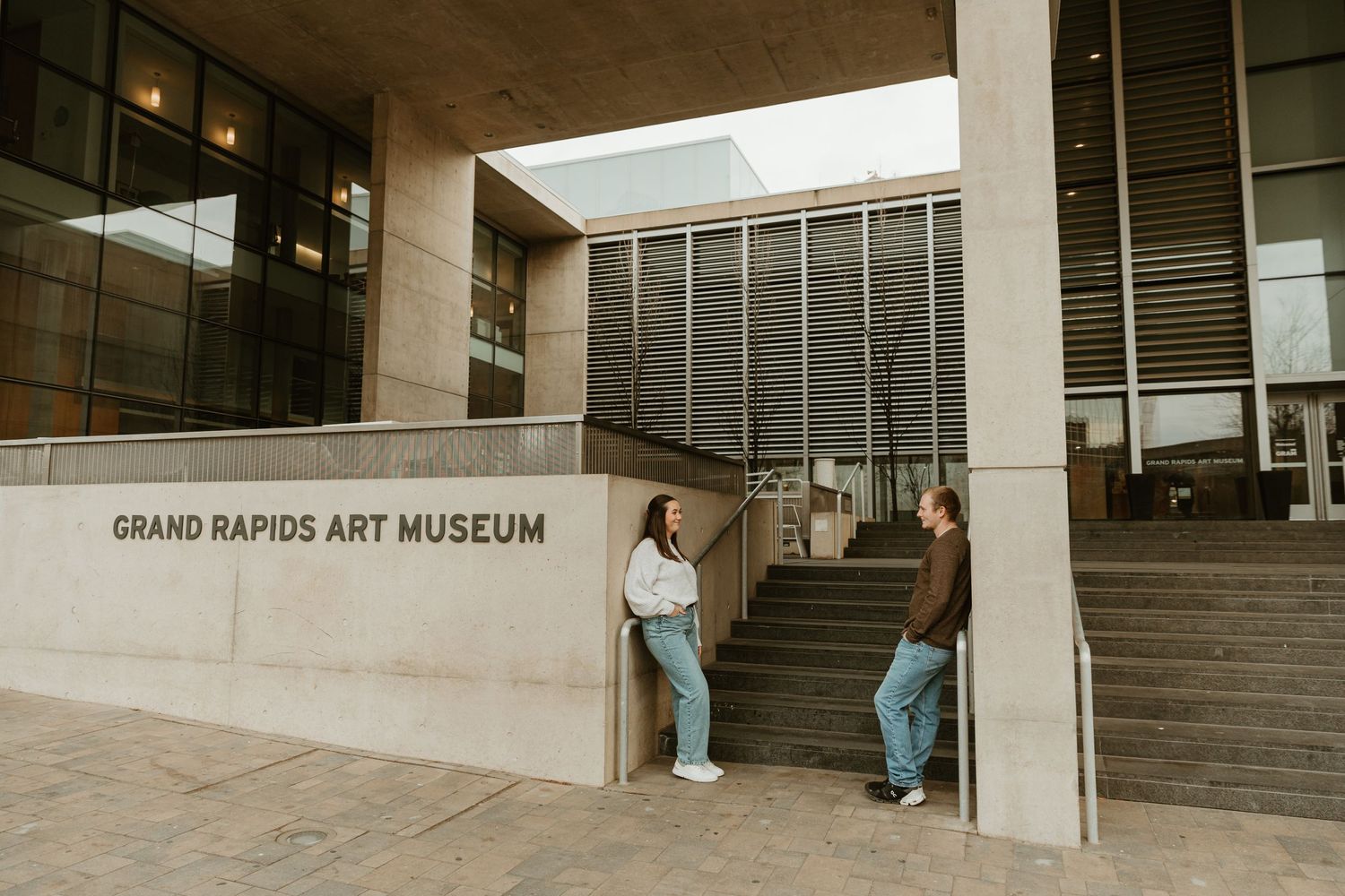 Exterior view of the Grand Rapids Art Museum entrance with steps and visitors.