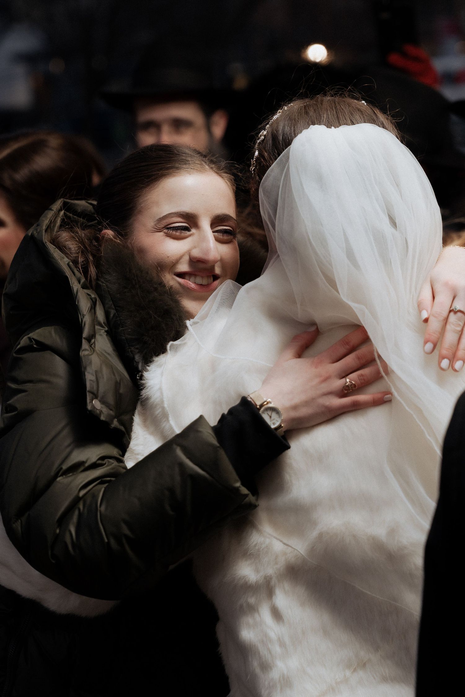 A joyful wedding moment captured between two people embracing.
