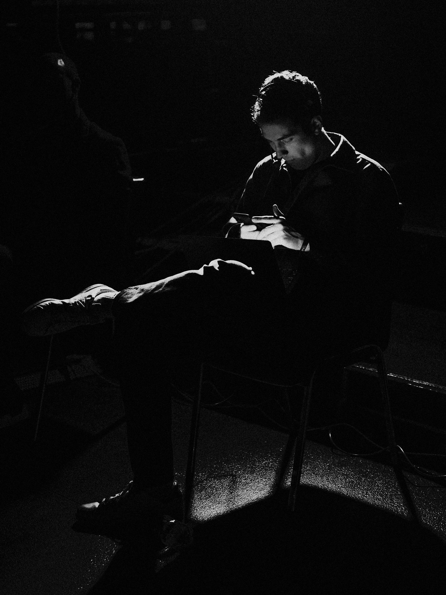 A Gather25 technician sitting at the backstage while coordinating.