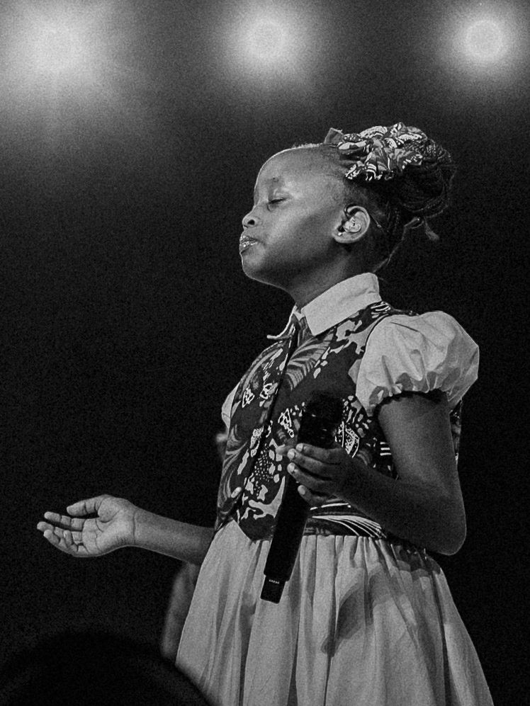 Watoto Kid praying