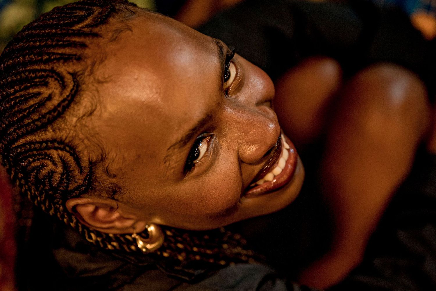 A top down shot of a beautiful young black lady smiling to the camera.