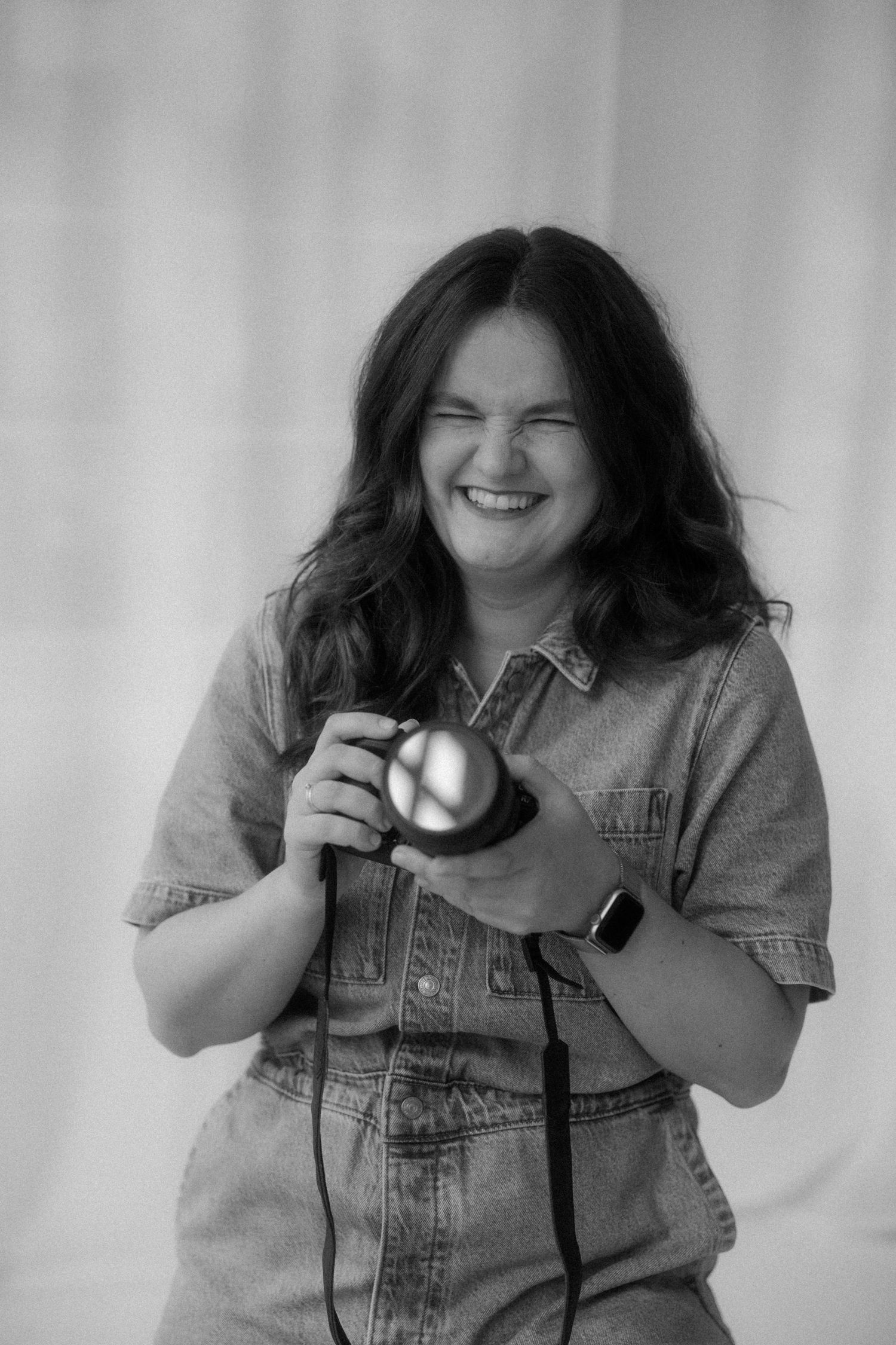 A sequence of black and white photos showing someone holding and examining a camera.