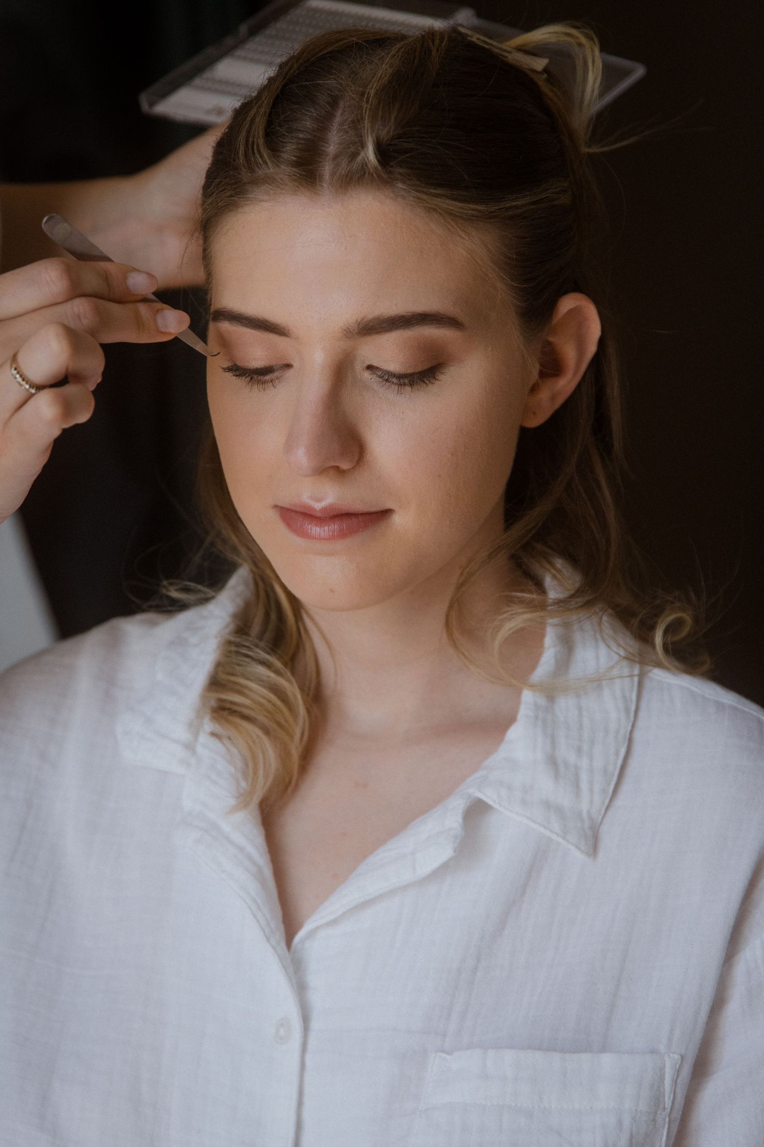 Close-up sequence of hair styling preparations in soft natural light.