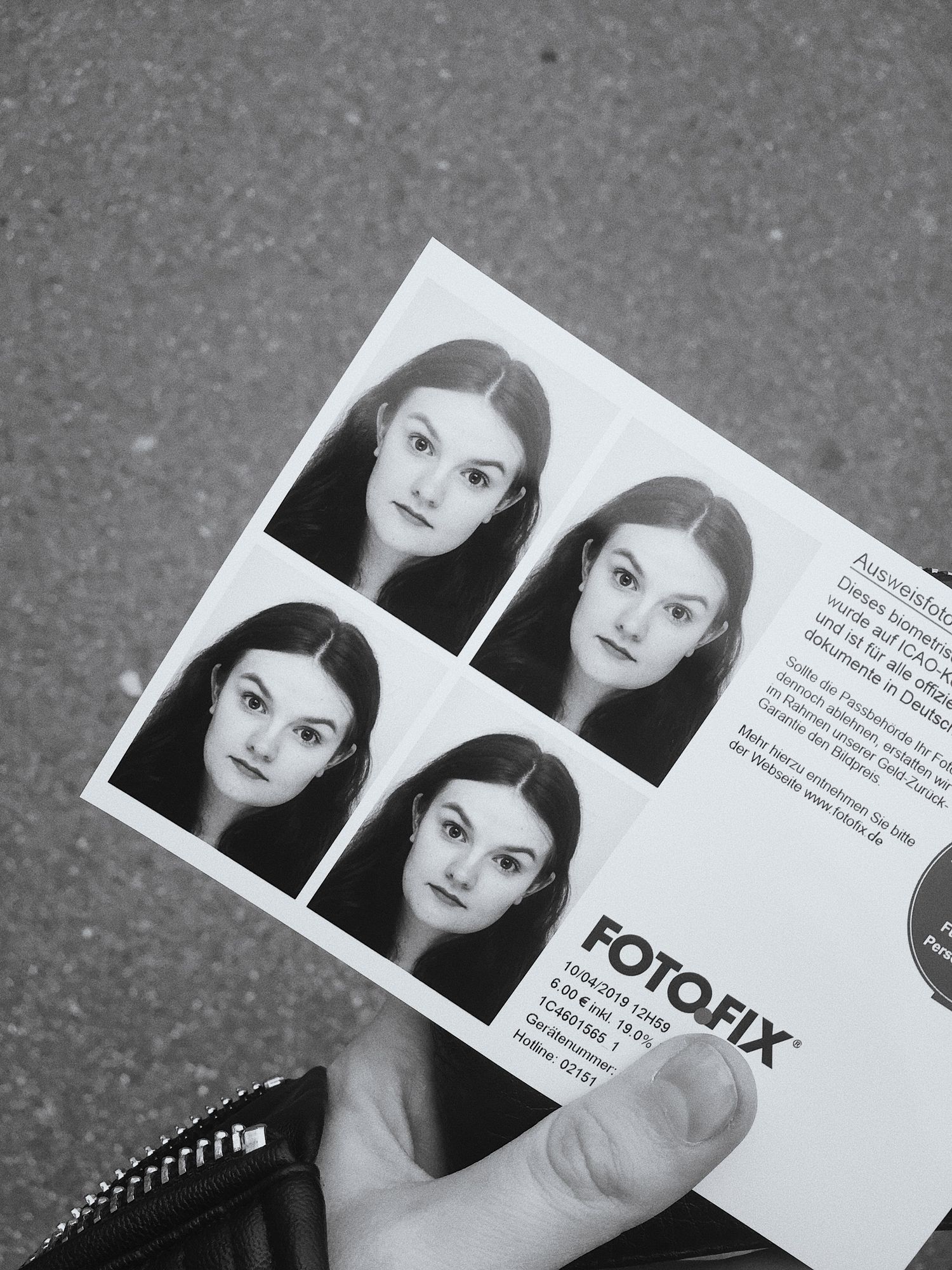 Vintage black and white photo booth style portrait strips laid out on a gray surface.