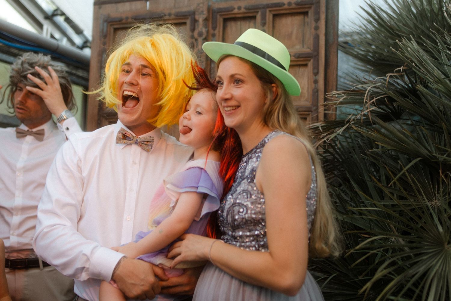 Wedding guests in colorful attire enjoying themselves at an outdoor celebration.