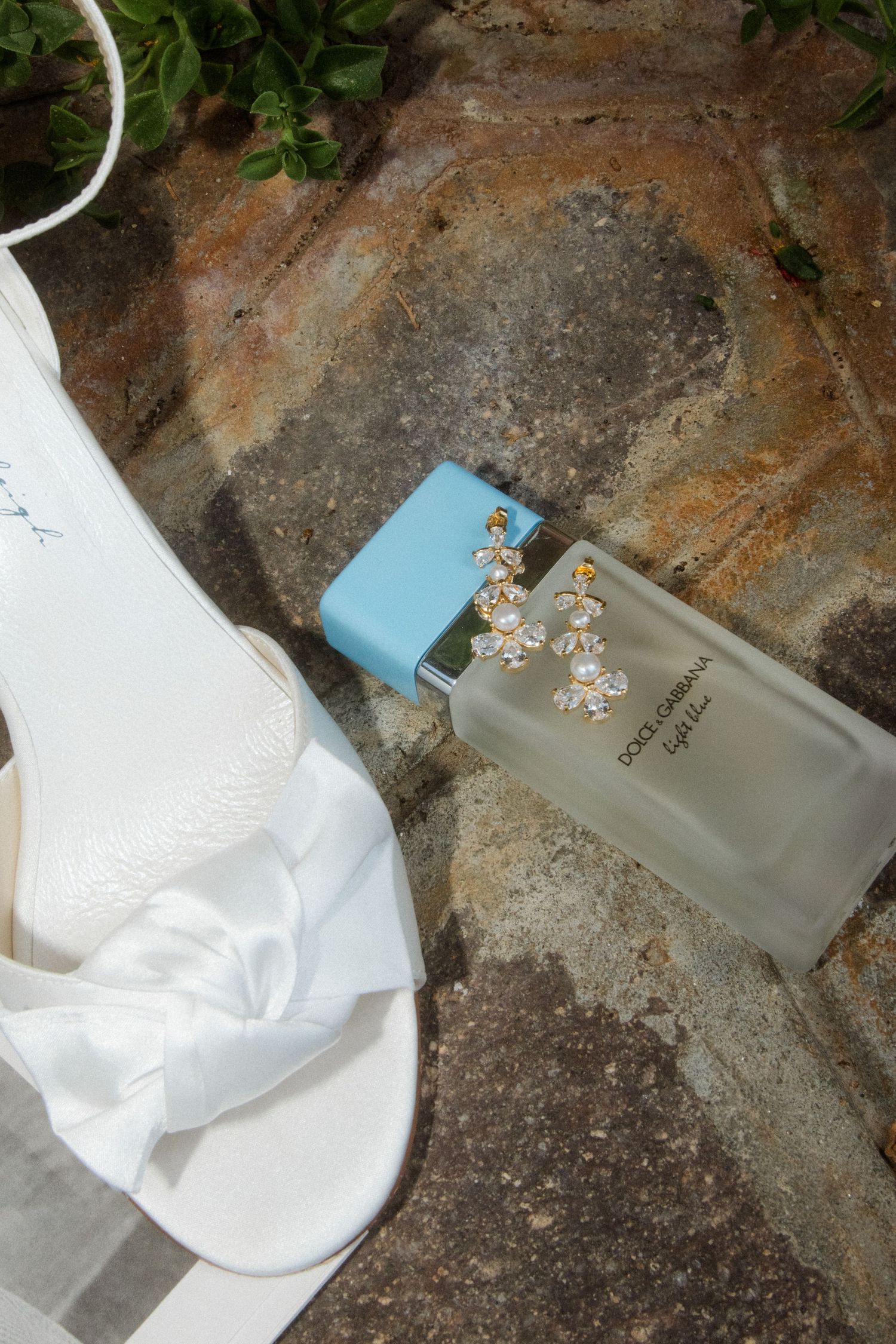 White fabric and decorative items arranged on weathered stone surface.