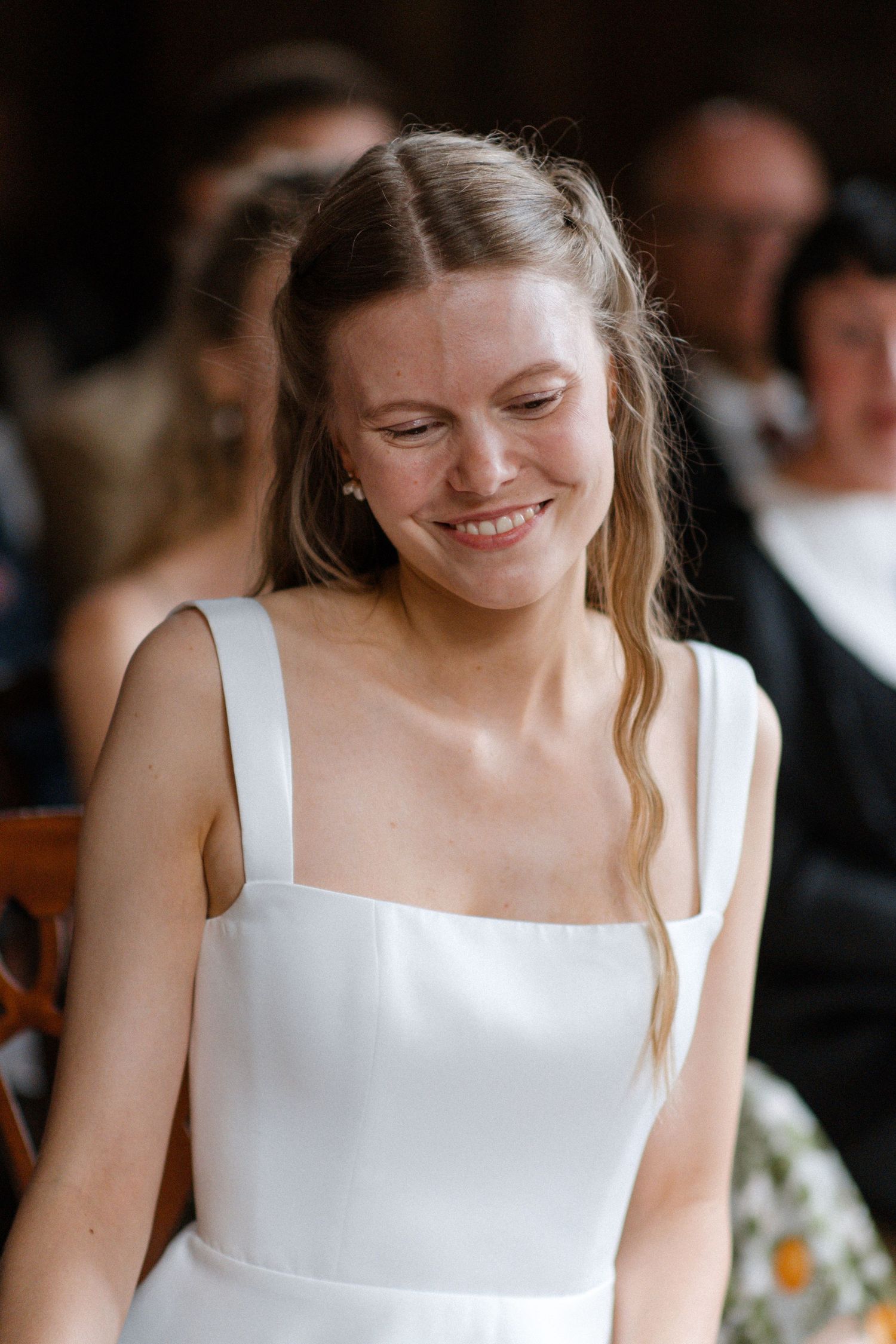 Close-up series of a bride in a white dress smiling during a wedding celebration.