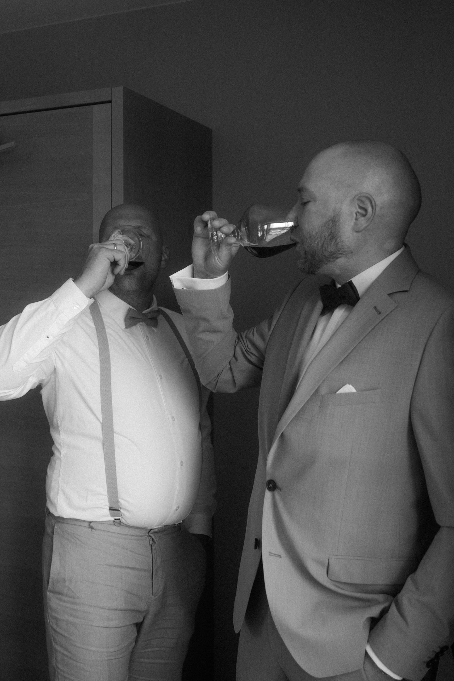 Black and white sequence of groomsmen adjusting their formal attire.