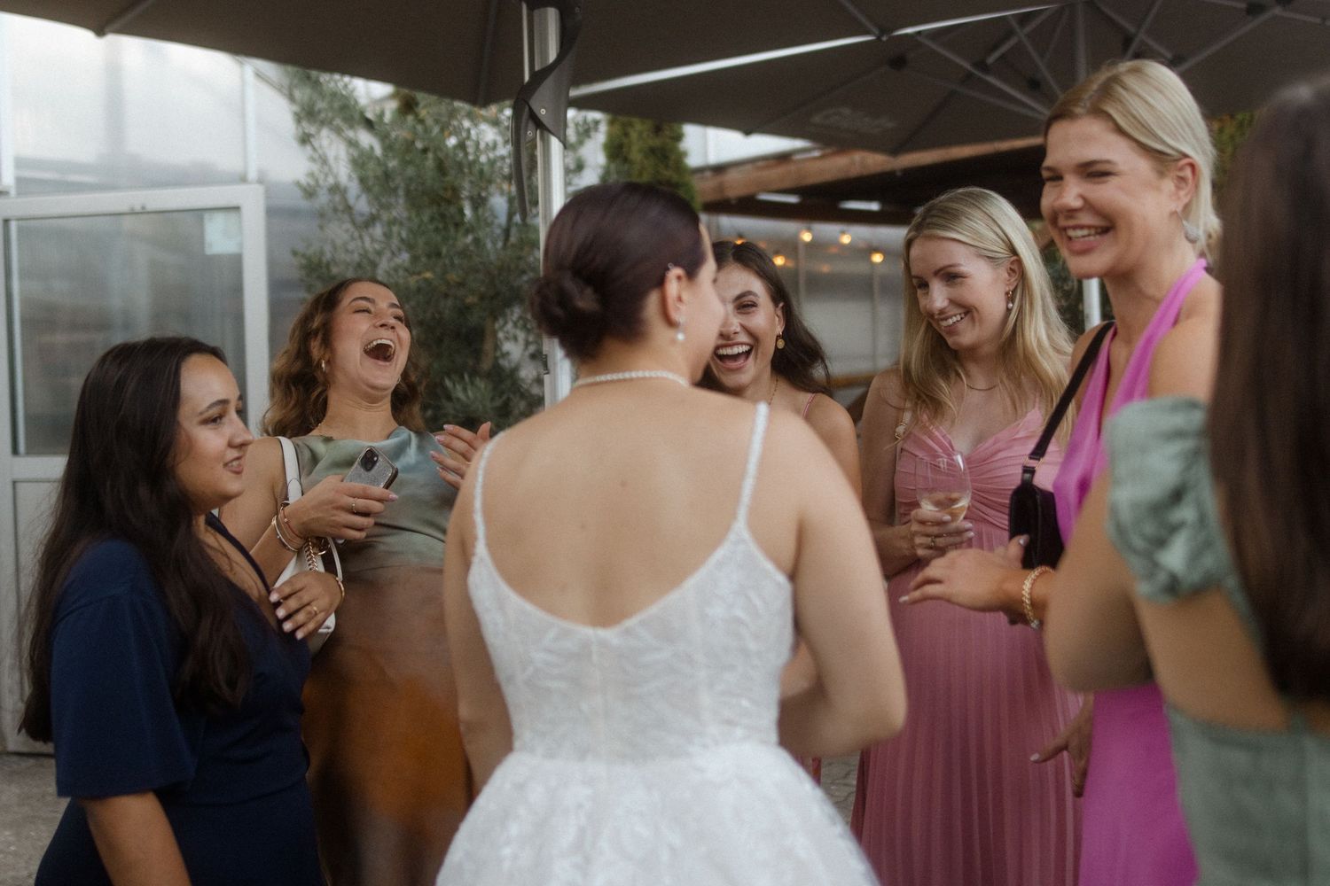 Wedding celebration with guests gathered outdoors sharing joyful moments.