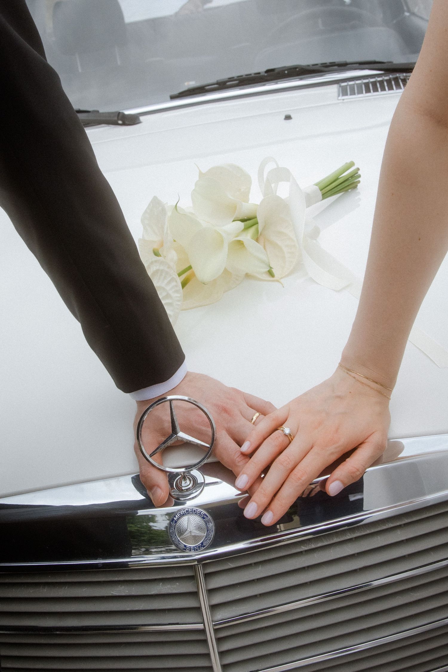 Close-up of hands placing rings during a wedding ceremony.