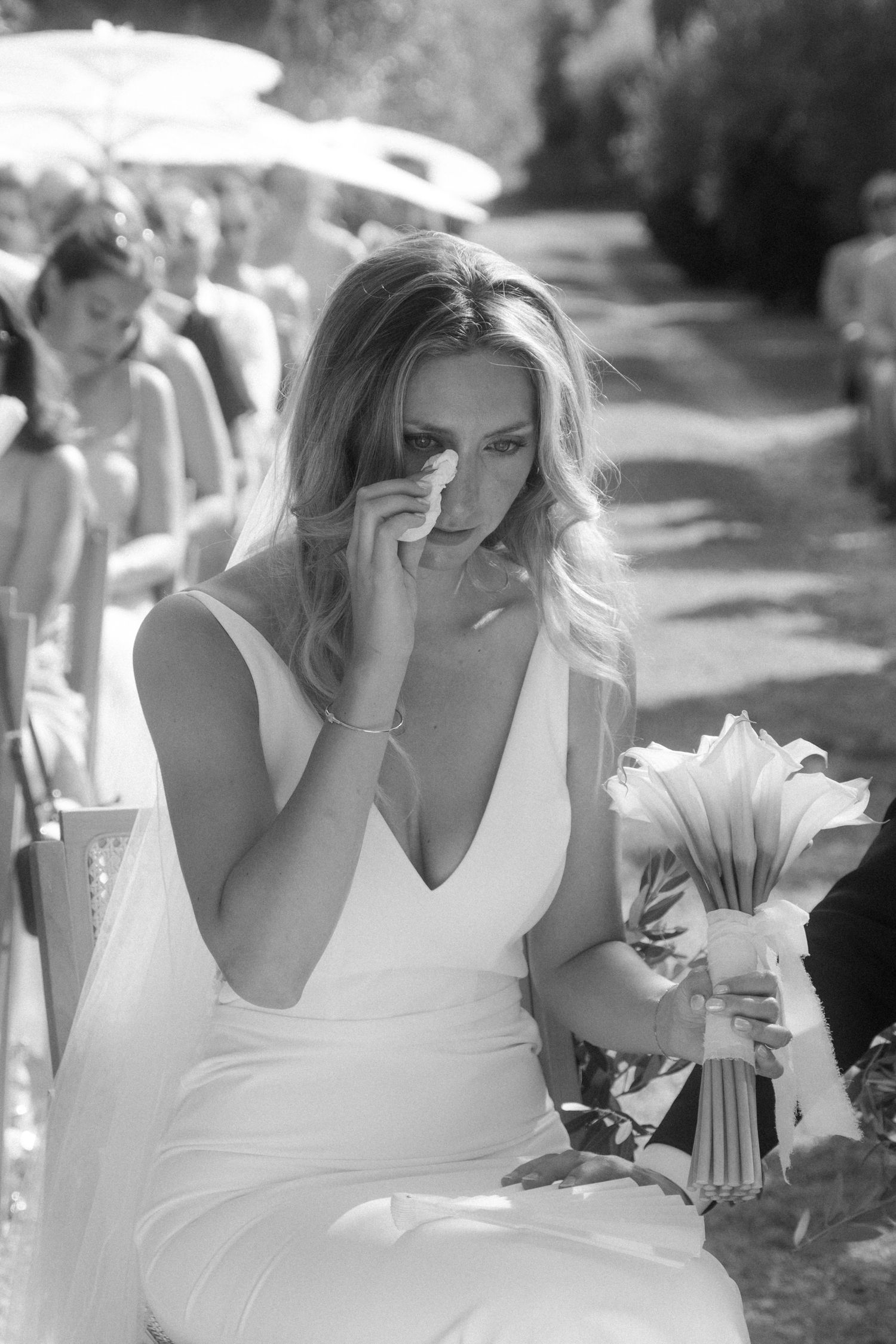 Emotional moment captured in black and white during an outdoor wedding ceremony.
