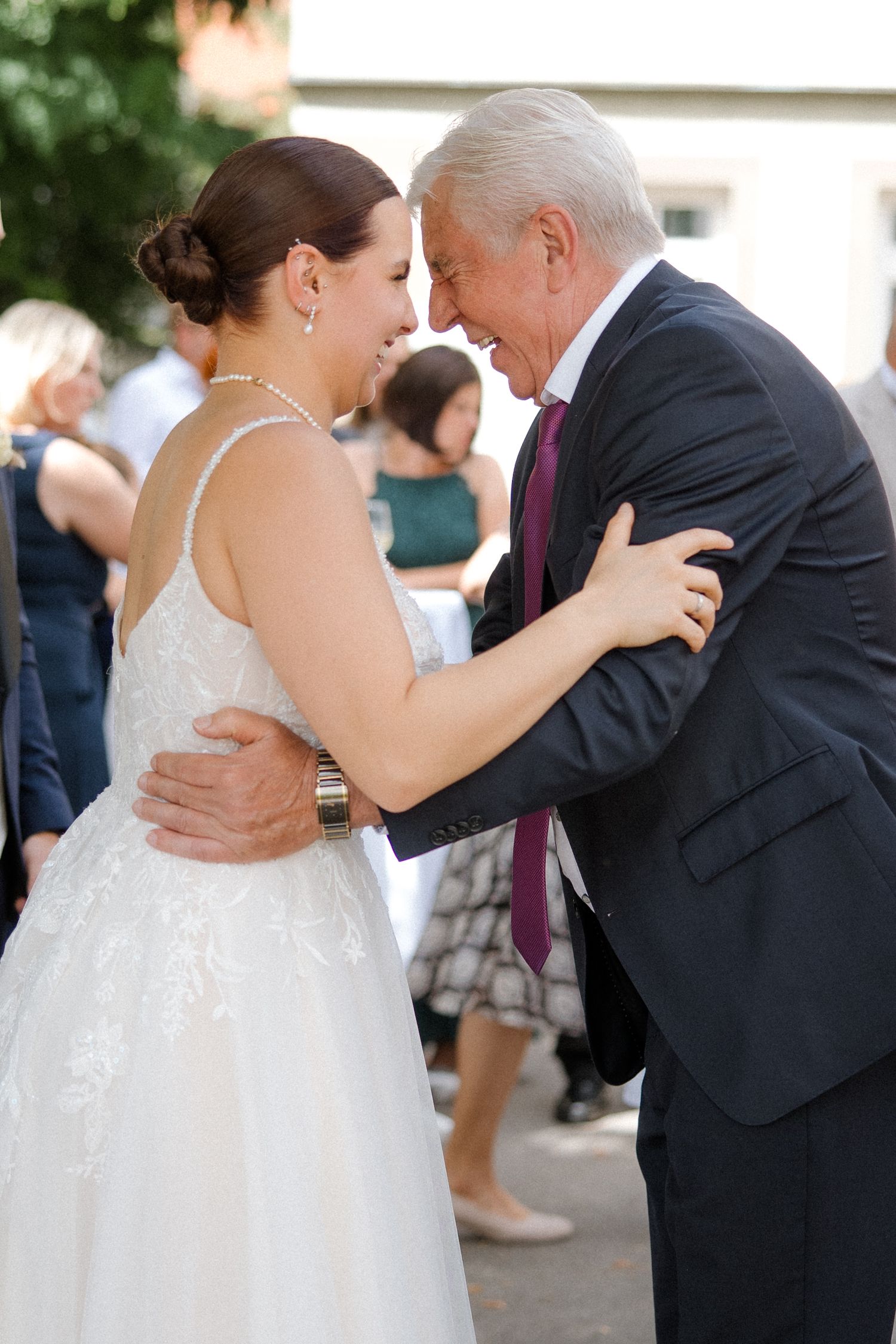 A heartwarming dance moment between wedding guests during an outdoor celebration.