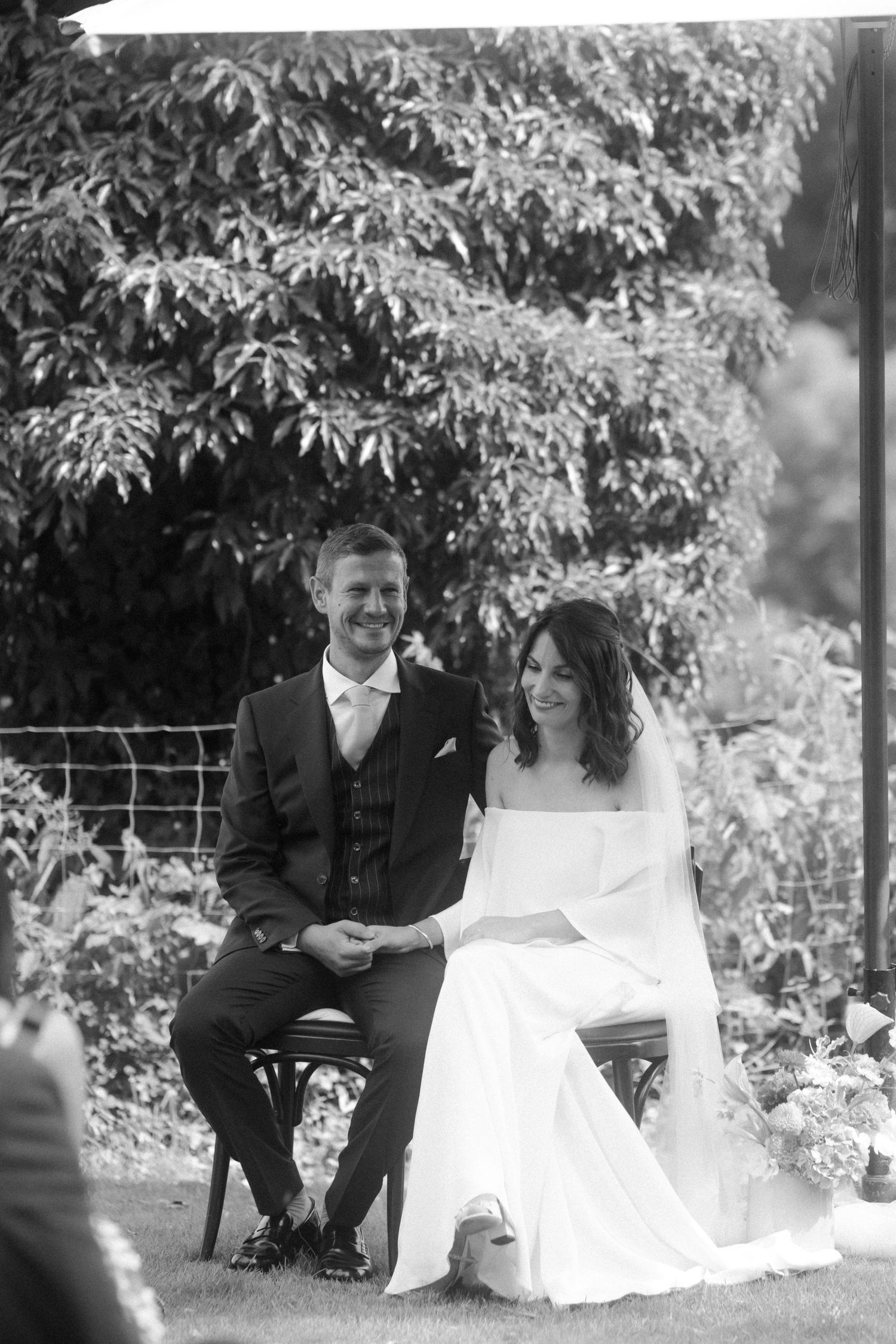 Newlyweds share an intimate moment during their outdoor garden wedding ceremony.