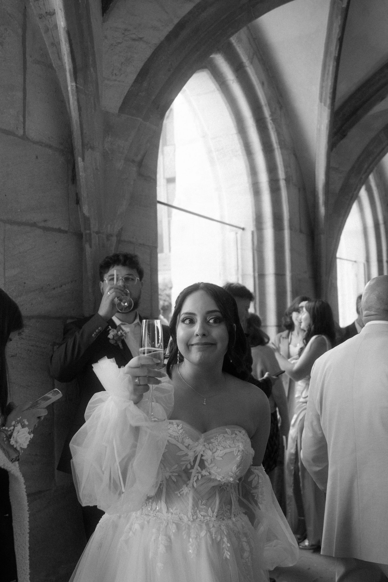 Black and white photos of wedding guests celebrating in a historic church setting.