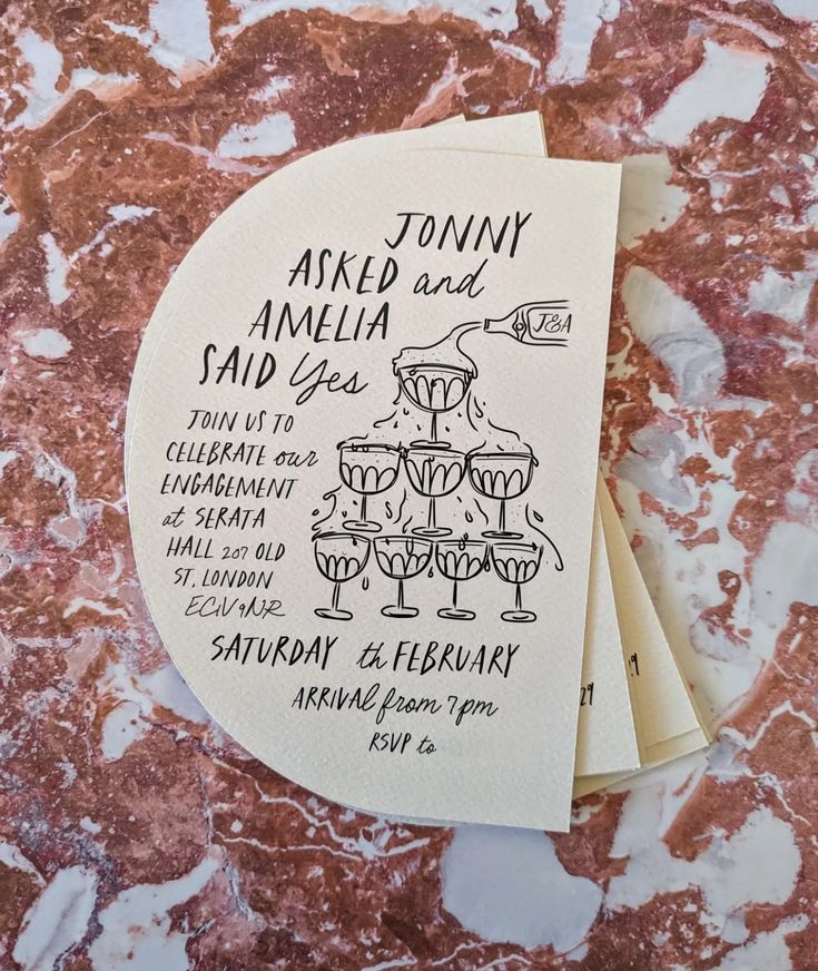 Wedding invitation for Tommy and Amelia featuring hand-drawn champagne tower illustration.