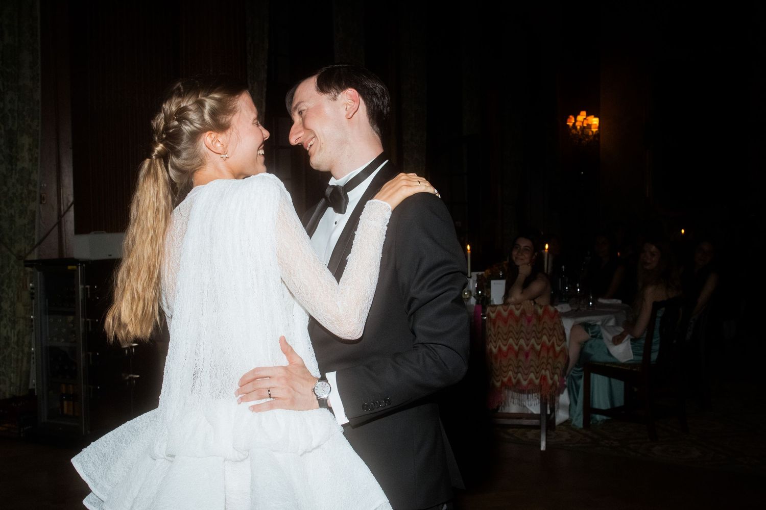 Dancing couple in formal wear sharing an intimate moment on the dance floor.
