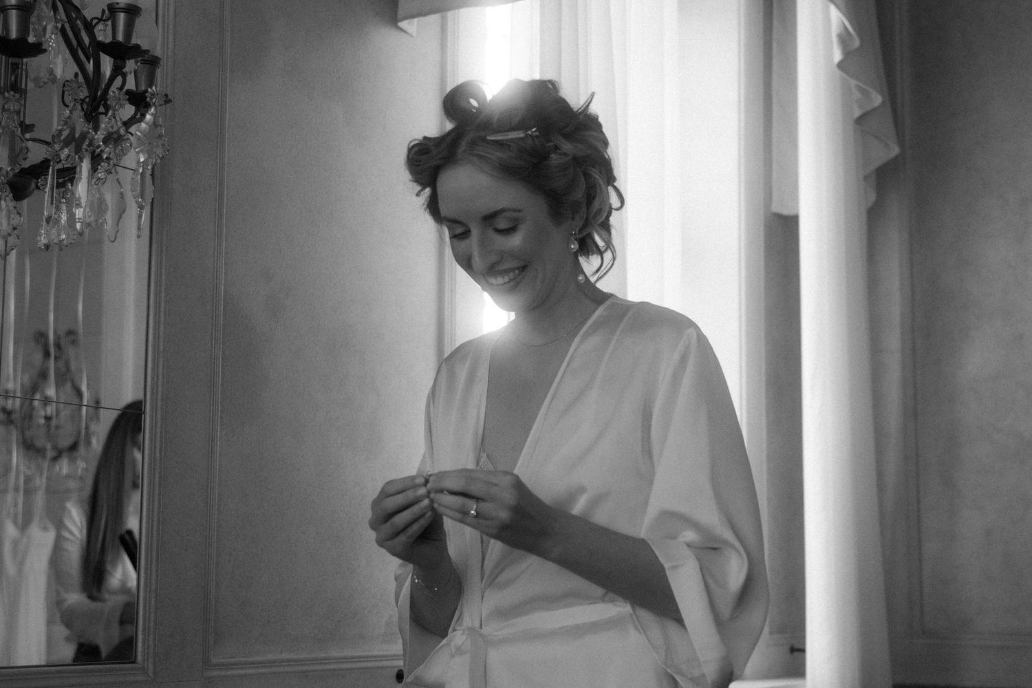 Black and white series of getting ready moments in a classically decorated room.