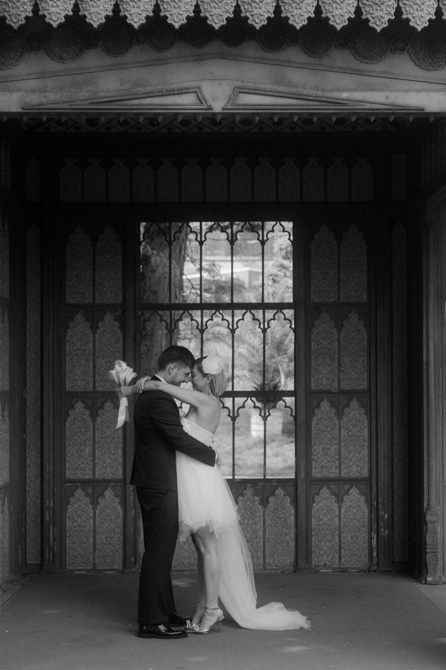 Black and white photo of newlyweds sharing an intimate dance pose.