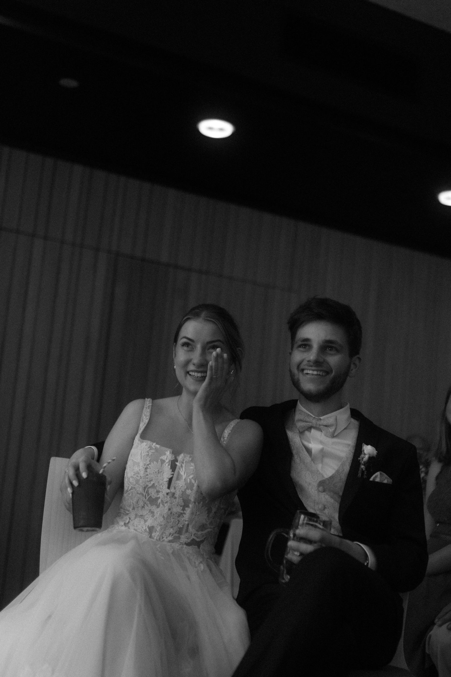 Black and white photo showing laughter and celebration at a formal event.