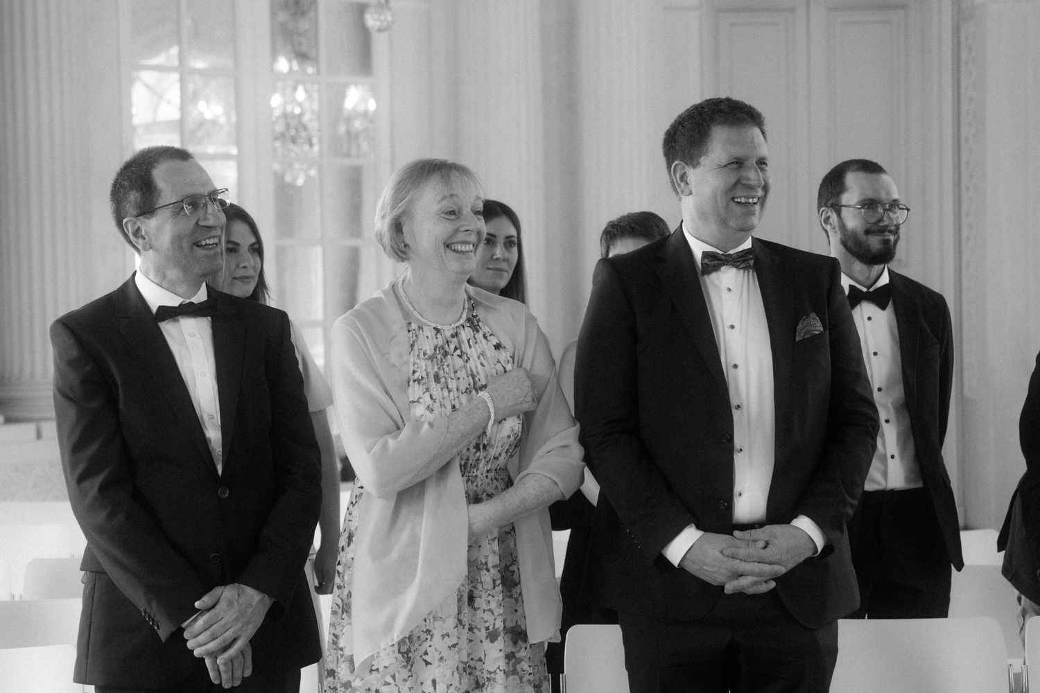 A series of candid moments captured during a wedding celebration in an ornate white venue.