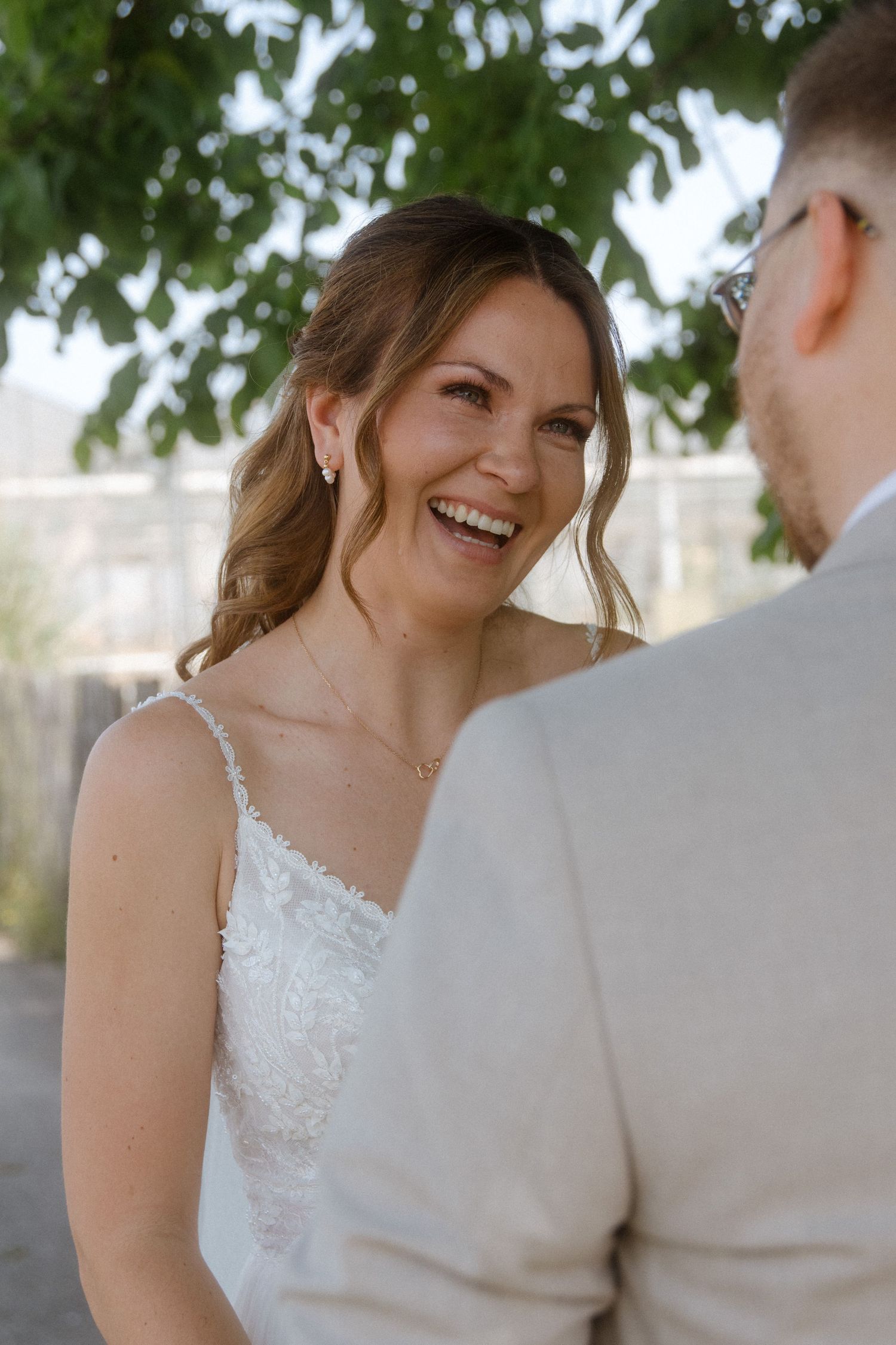 A close-up sequence shows a joyful wedding moment between two people outdoors under green foliage.