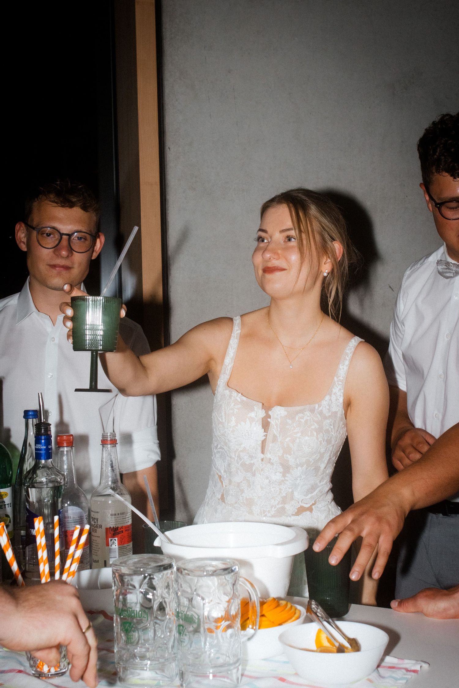 A festive party scene with drinks and table settings decorated with fresh flowers.