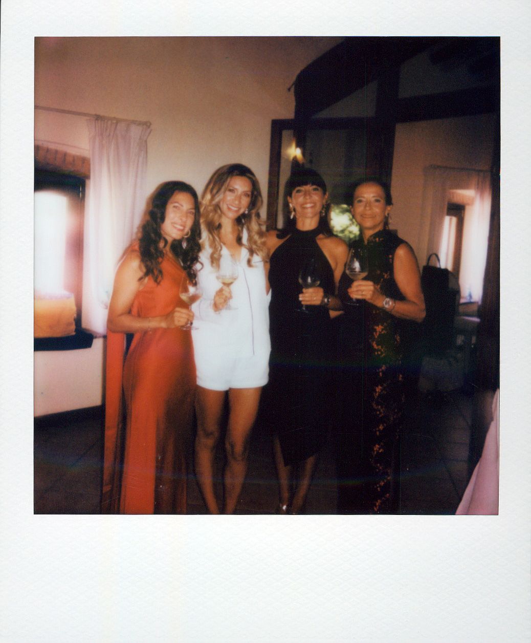 Group photo of wedding guests gathered indoors during a celebration.