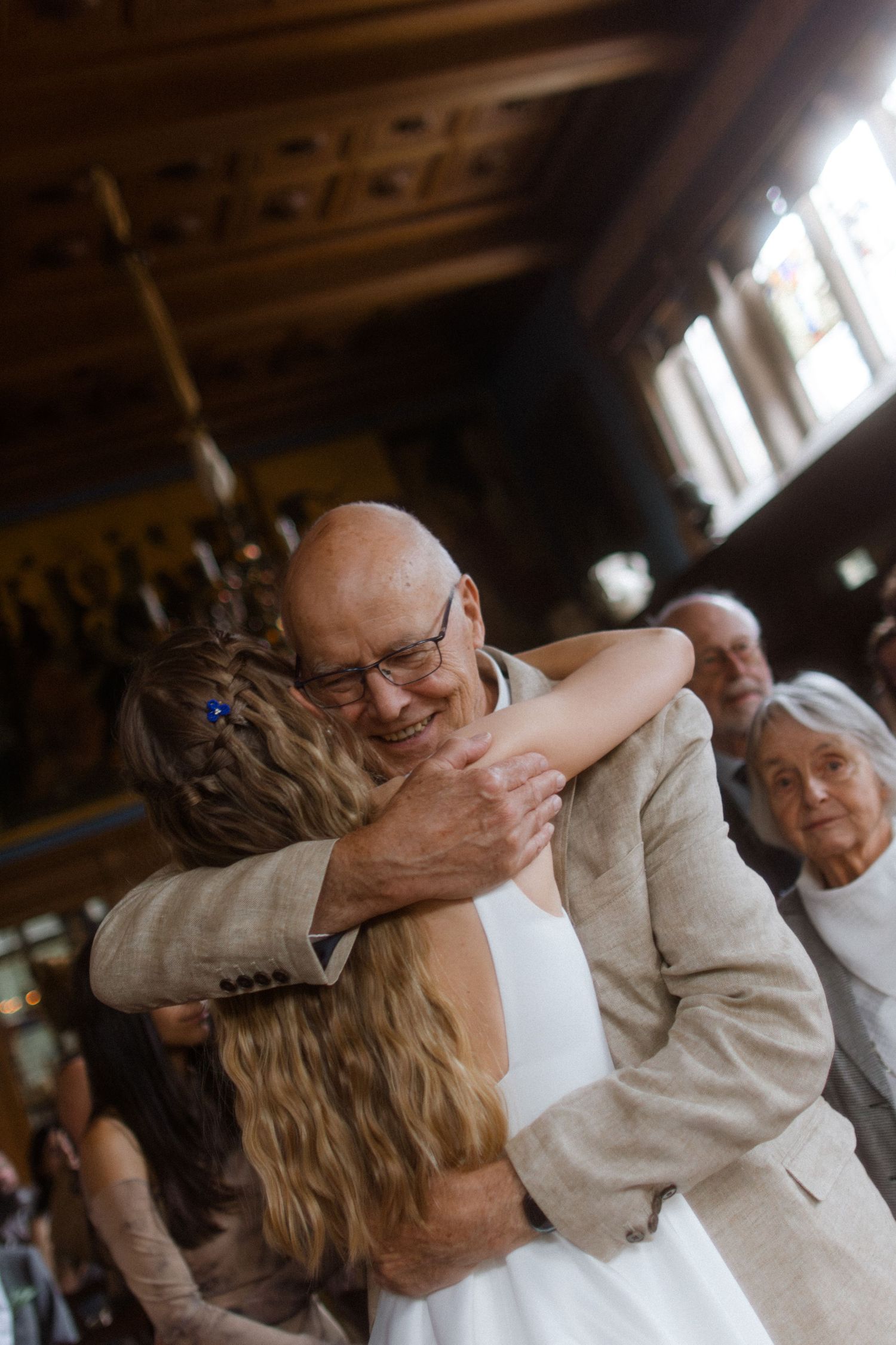 Couple sharing a playful dance move during their wedding celebration.