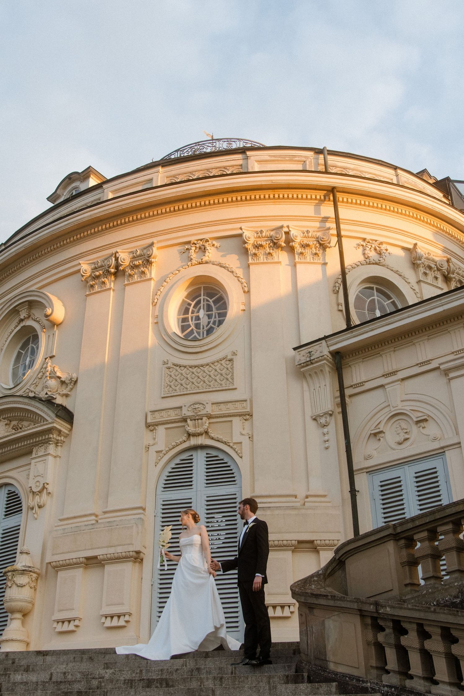 Elegant architectural details of a classical building with ornate decorative elements at sunset.