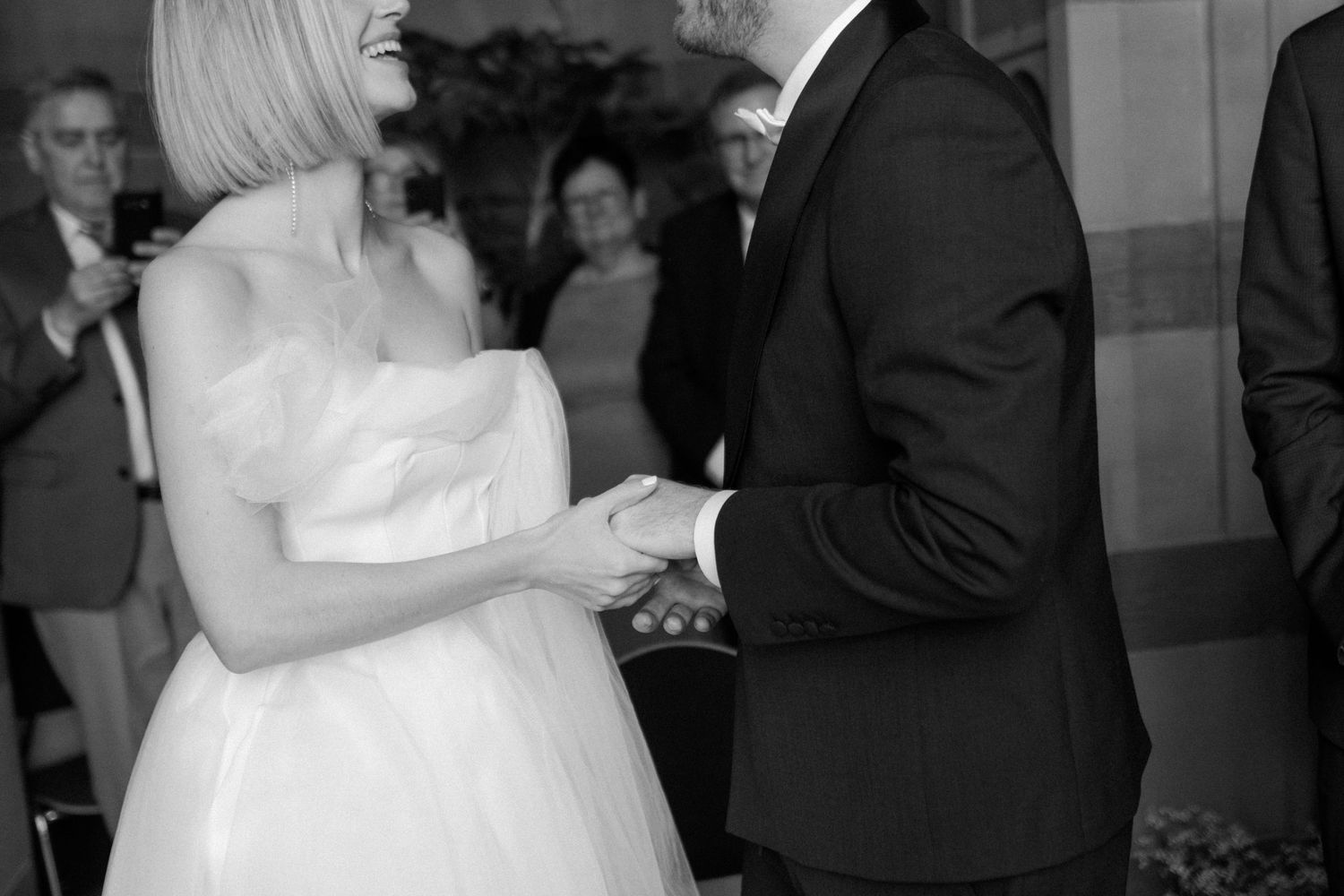 Black and white candid shots of a couple sharing intimate moments during their wedding celebration.