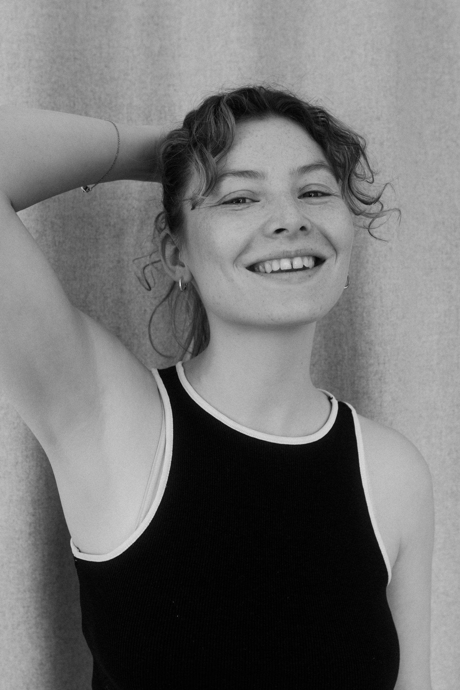 Black and white portrait series showing joyful expressions and candid smiles in artistic composition.