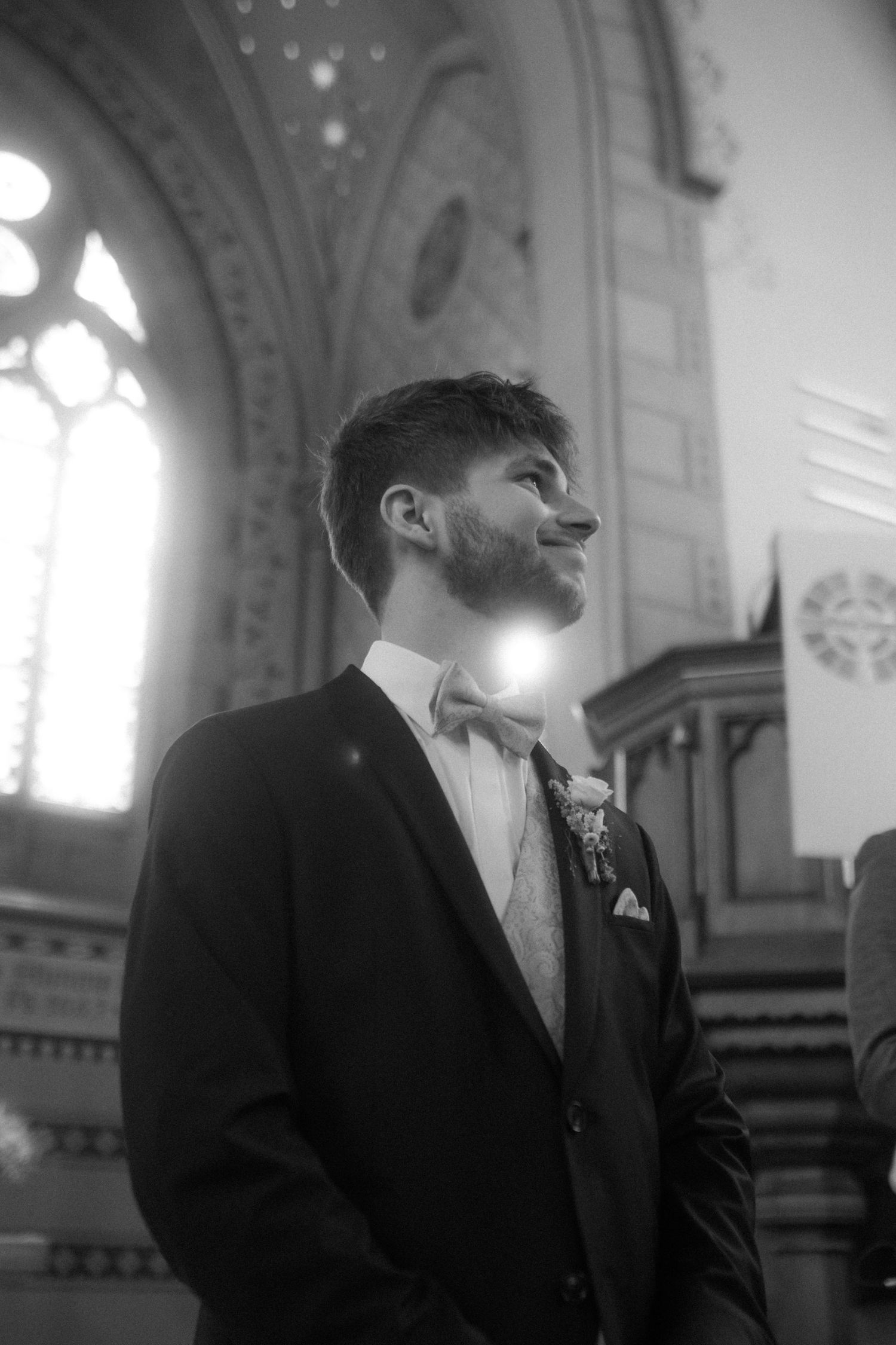 Dramatic black and white profile shots inside a church with gothic architecture.