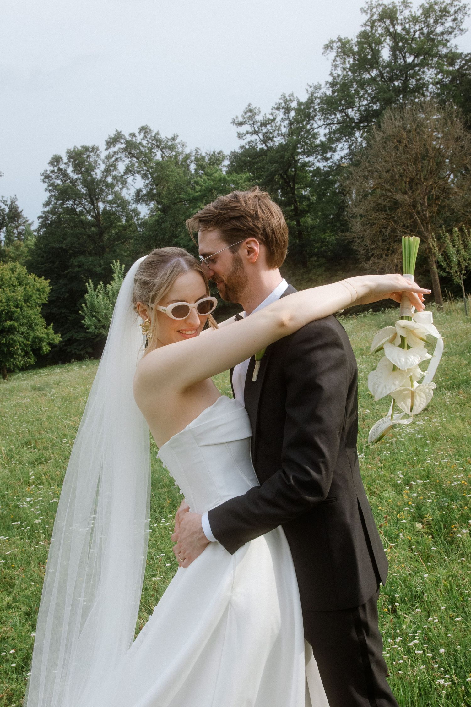 A wedding couple shares intimate moments in a wildflower field during their photoshoot.
