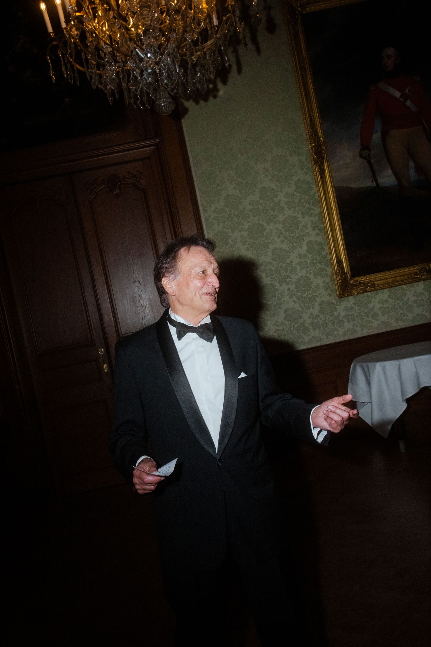 Guest in formal black tuxedo at elegant evening reception.