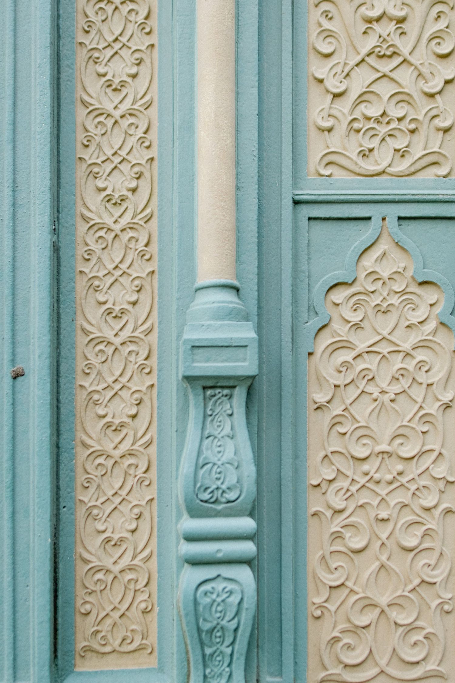 Ornate architectural detail showing turquoise and cream colored decorative moldings.
