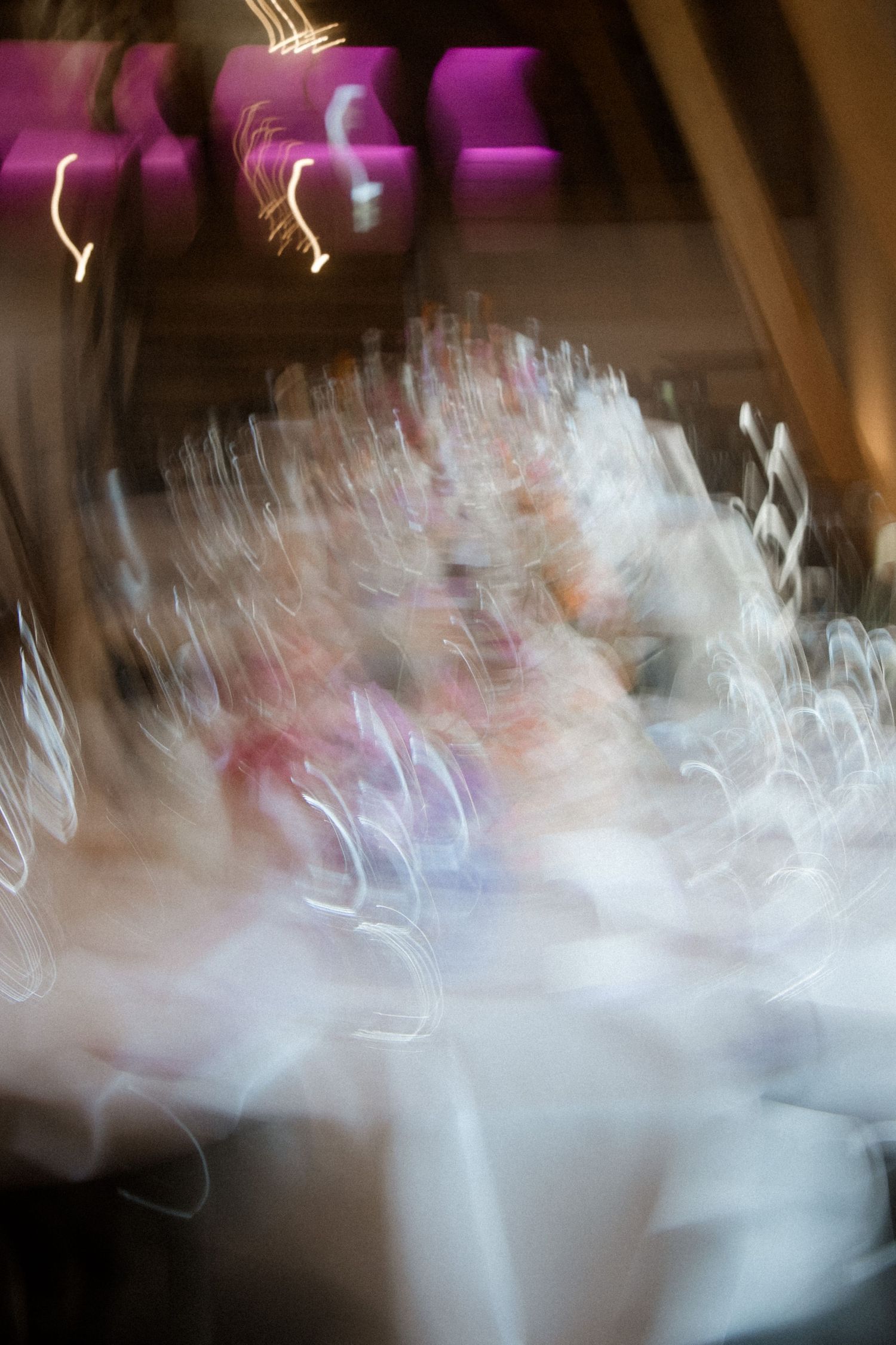 Abstract blurred motion photograph with white and pink lights creating an ethereal effect.