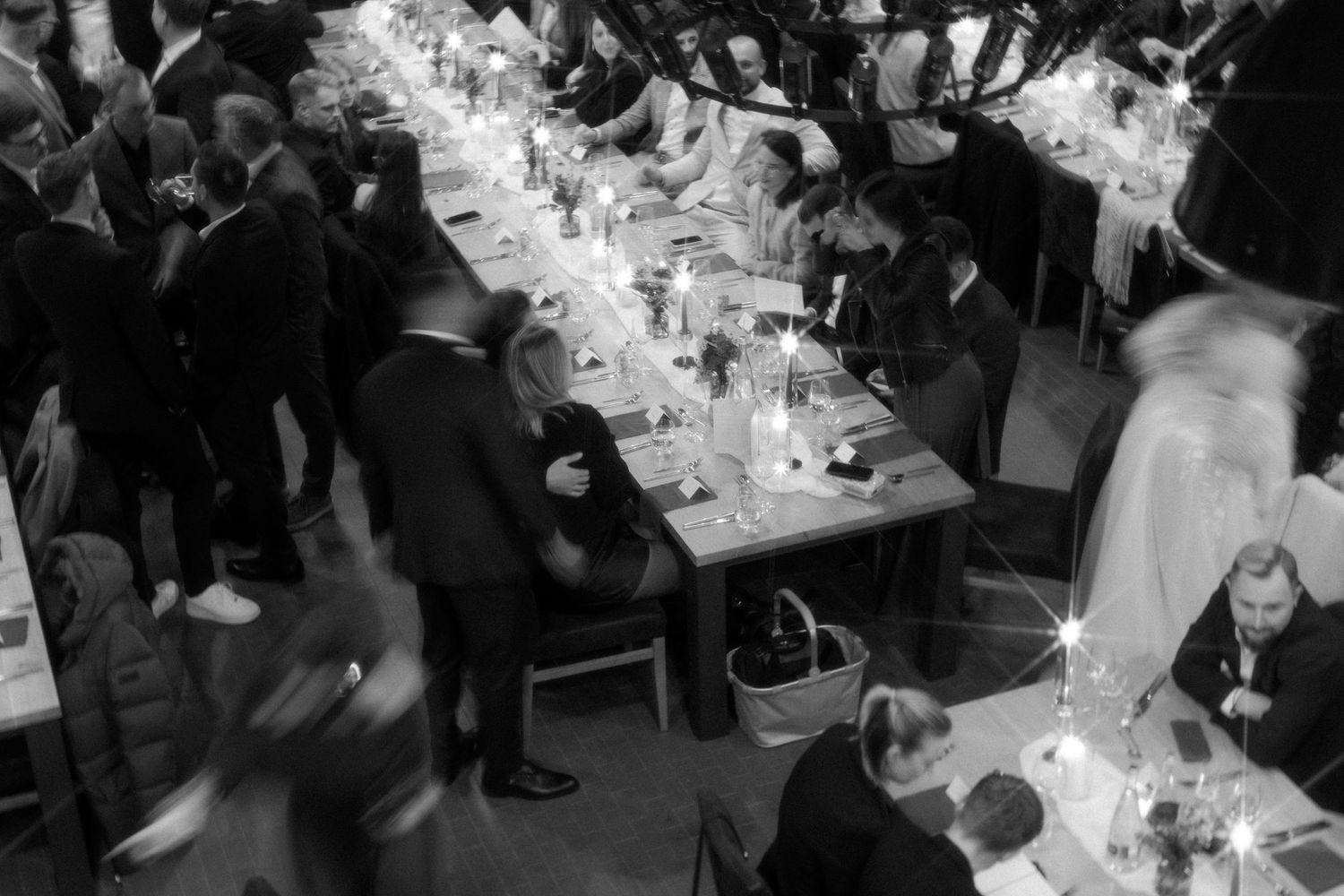 Overhead view of wedding reception tables with guests seated for dinner.