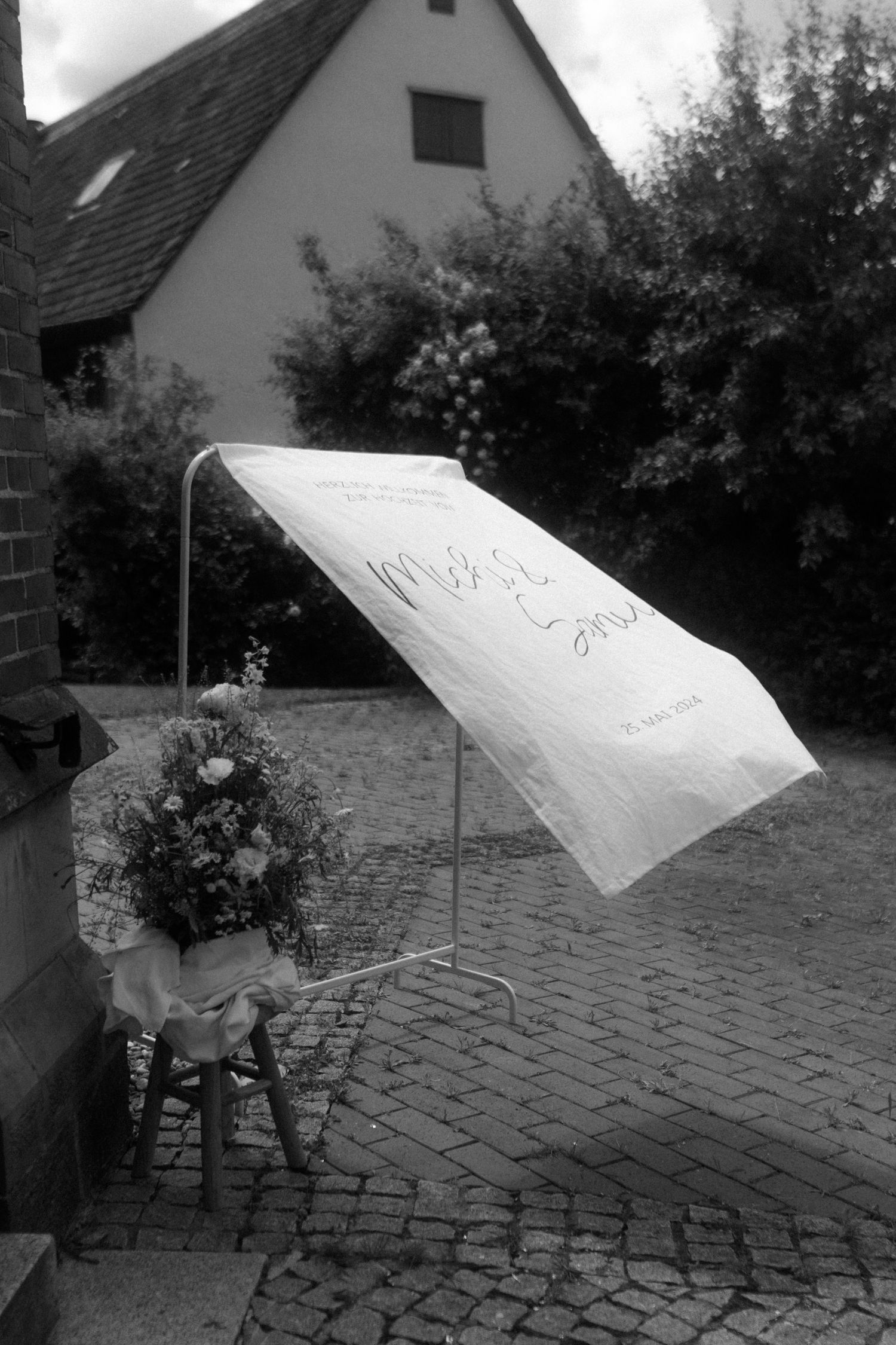 Series of black and white photos showing a white sheet blowing in the wind.