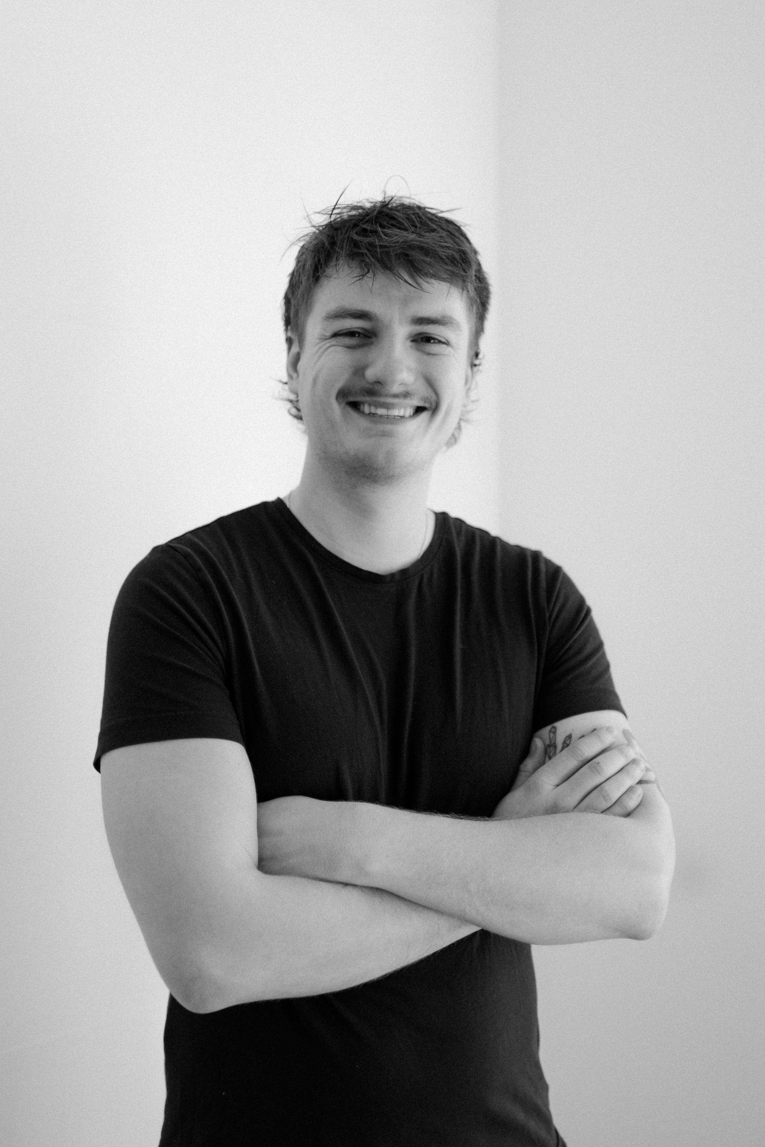Black and white portraits showing different expressions and poses against a white background.