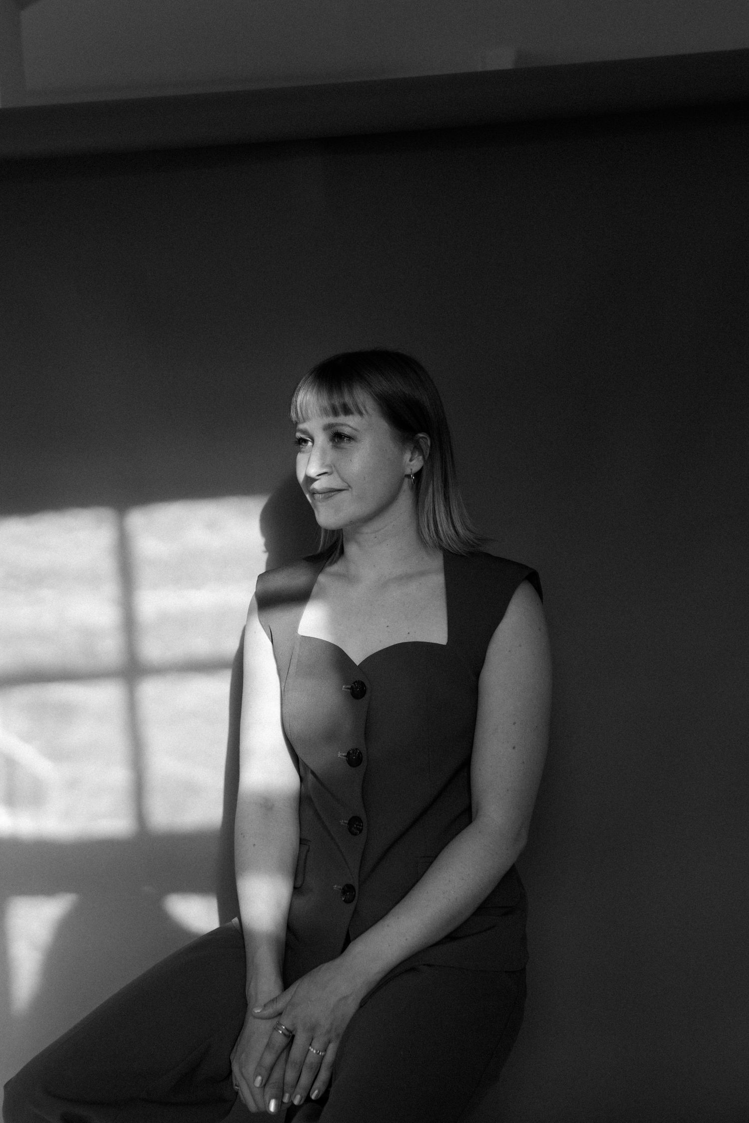 Artistic black and white portraits showing dramatic lighting and shadows on dark background.