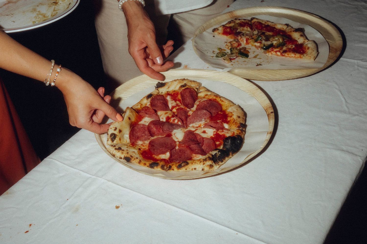 A sequence of photos showing a pizza being eaten progressively from a full pie down to just a few remaining pieces.
