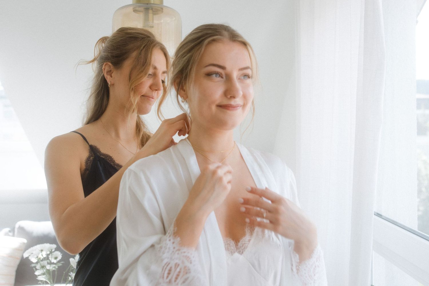Getting ready scene with two people in white and black attire.