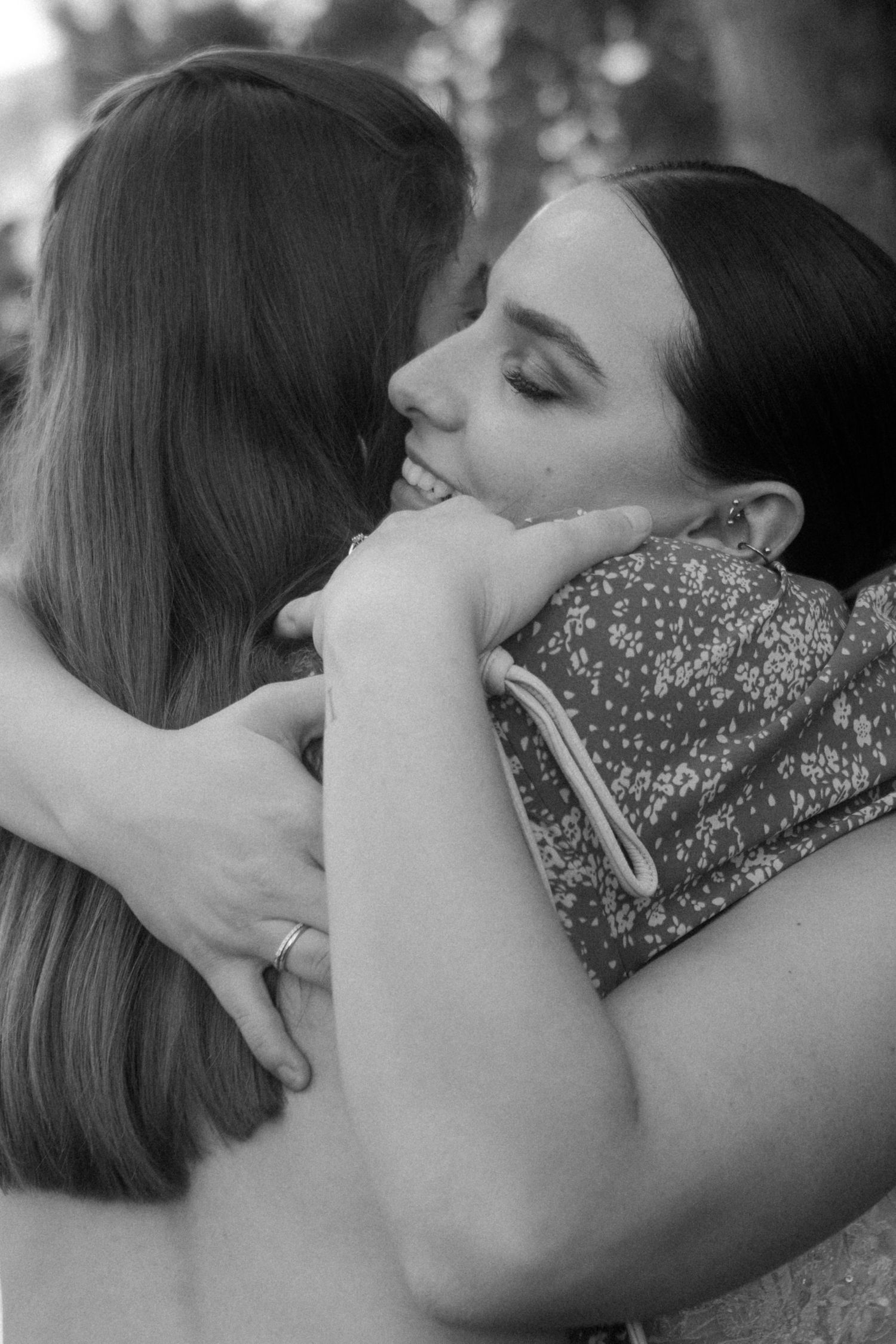 A tender moment captured in black and white as two people share an emotional embrace.