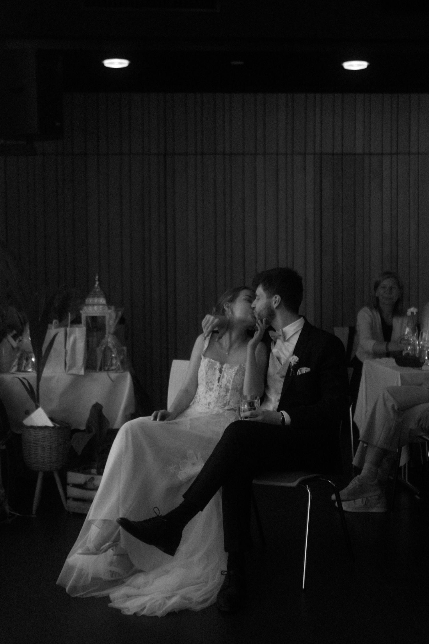Intimate black and white photo of a couple at their wedding reception.