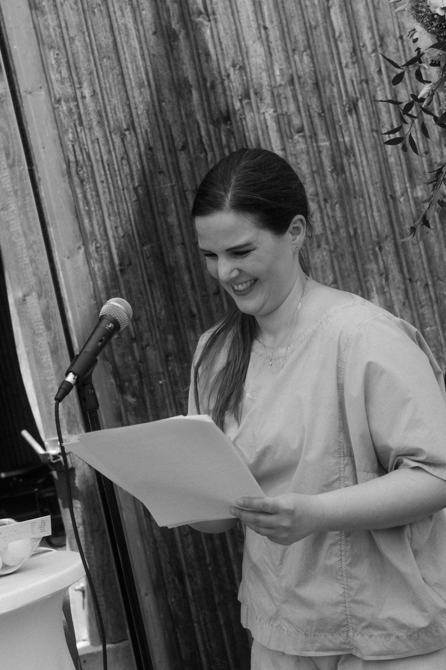 Black and white photo of a speaker delivering a speech at a microphone stand.