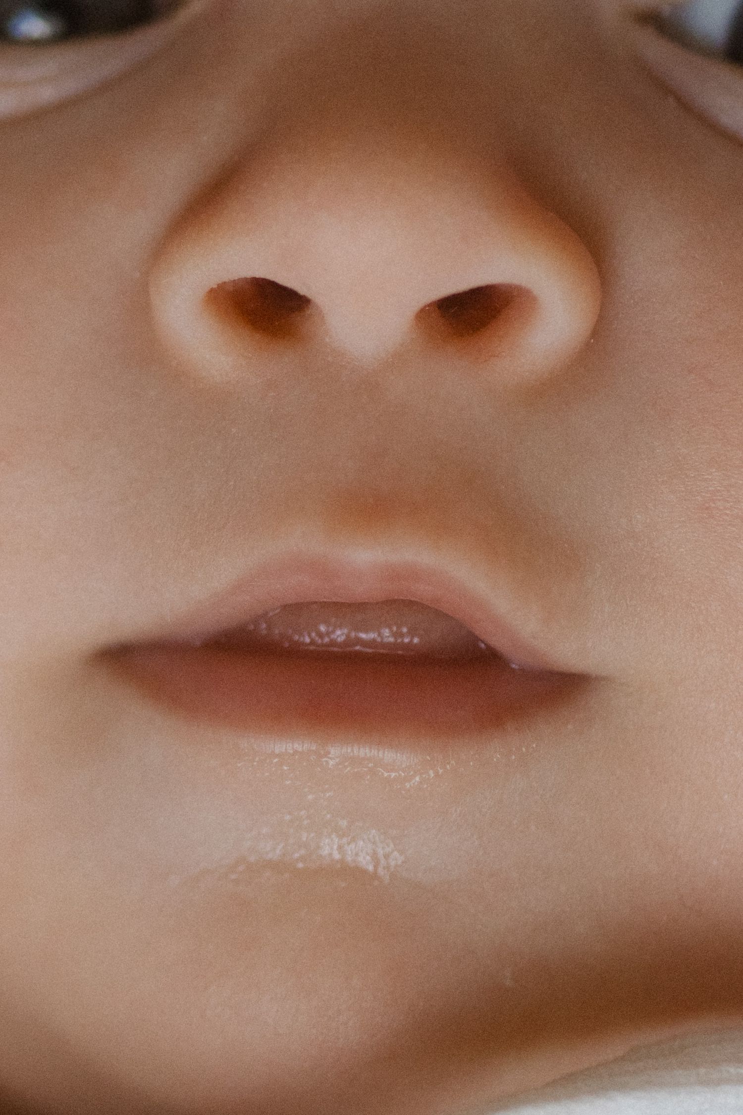 Extreme close-up macro shots of lips and nose features in sequence.