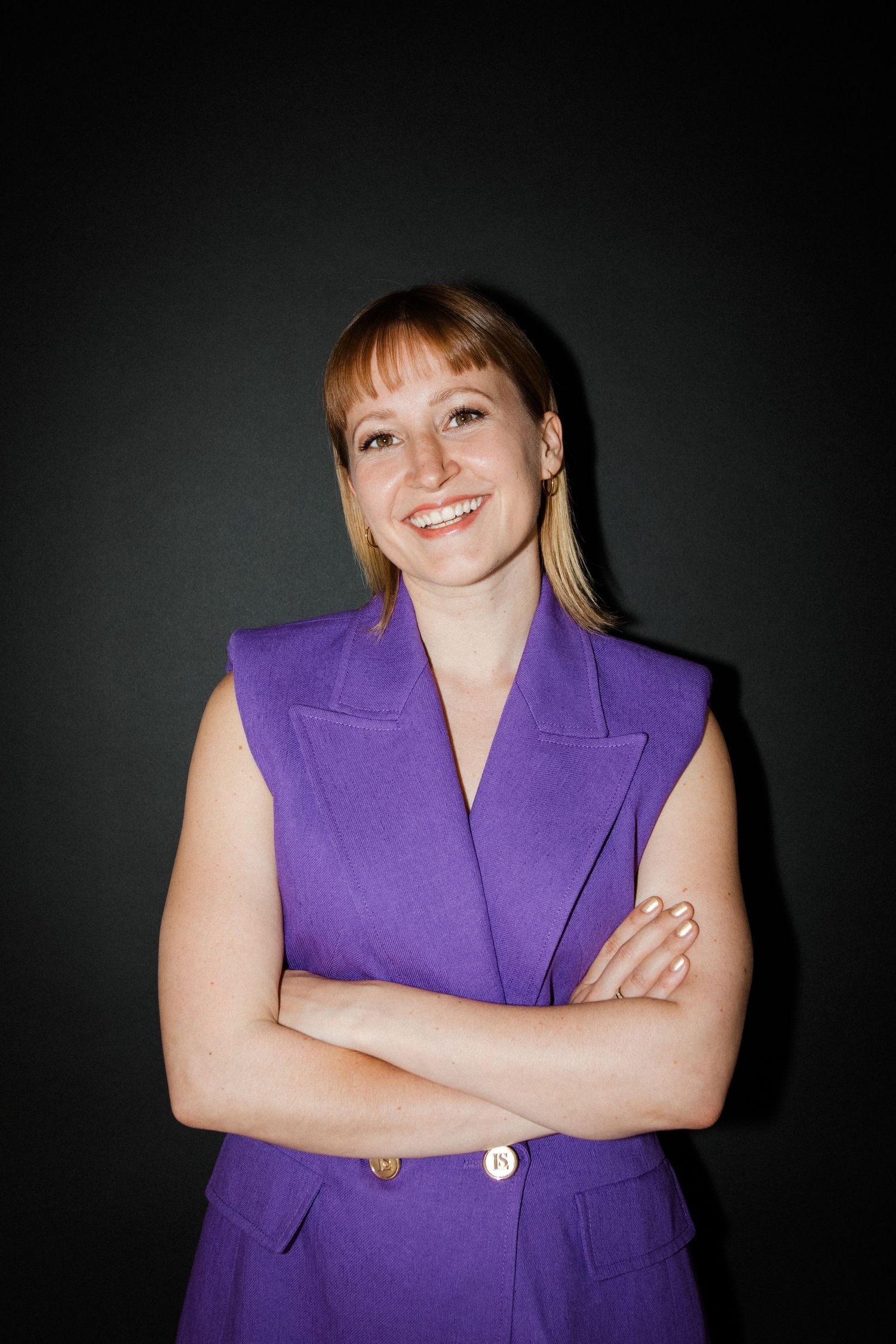 Professional portrait series showing a person wearing a vibrant purple sleeveless blazer against a dark background.