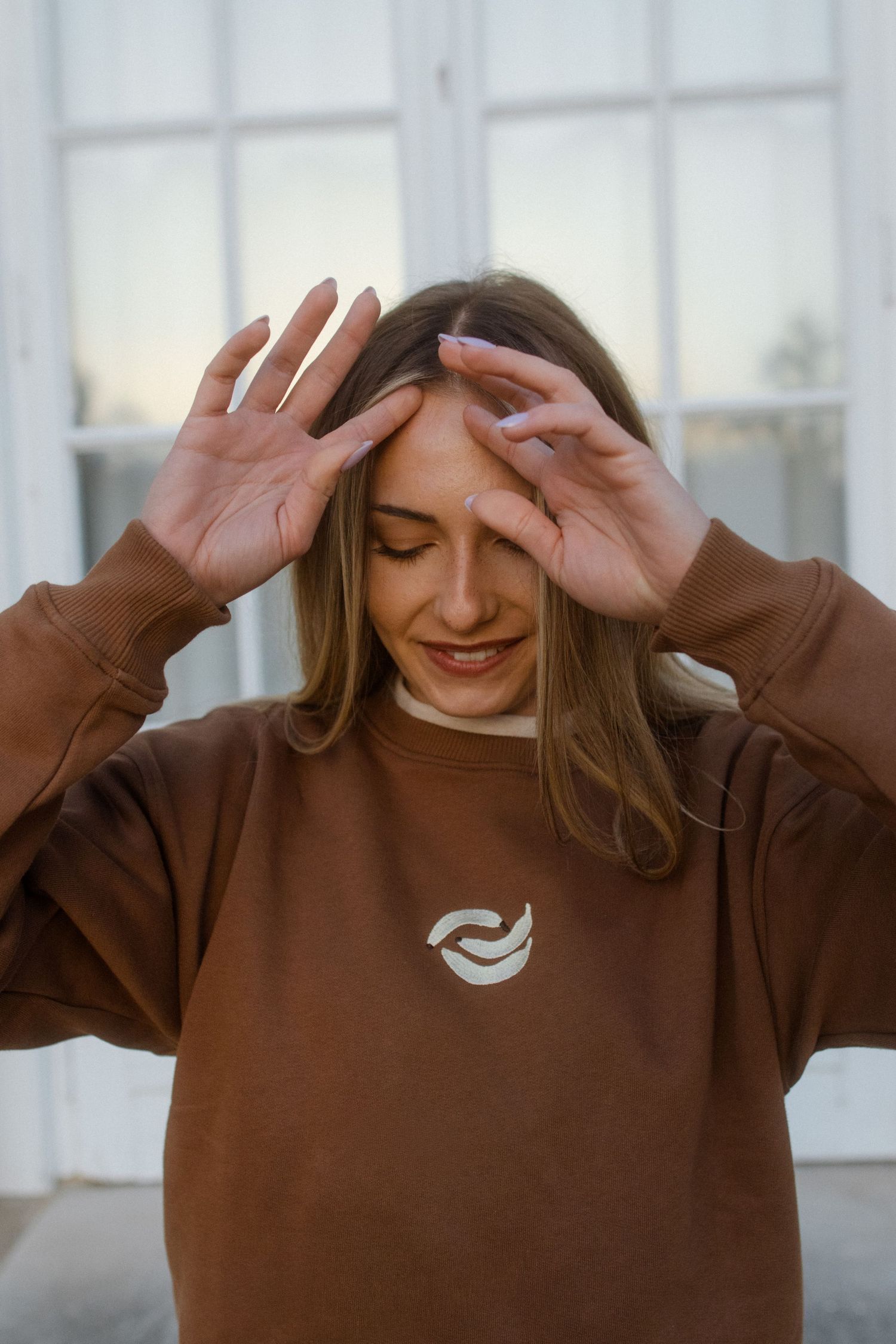 Person in brown sweatshirt with eyes closed showing emotional expressions in sequence of connected photos.