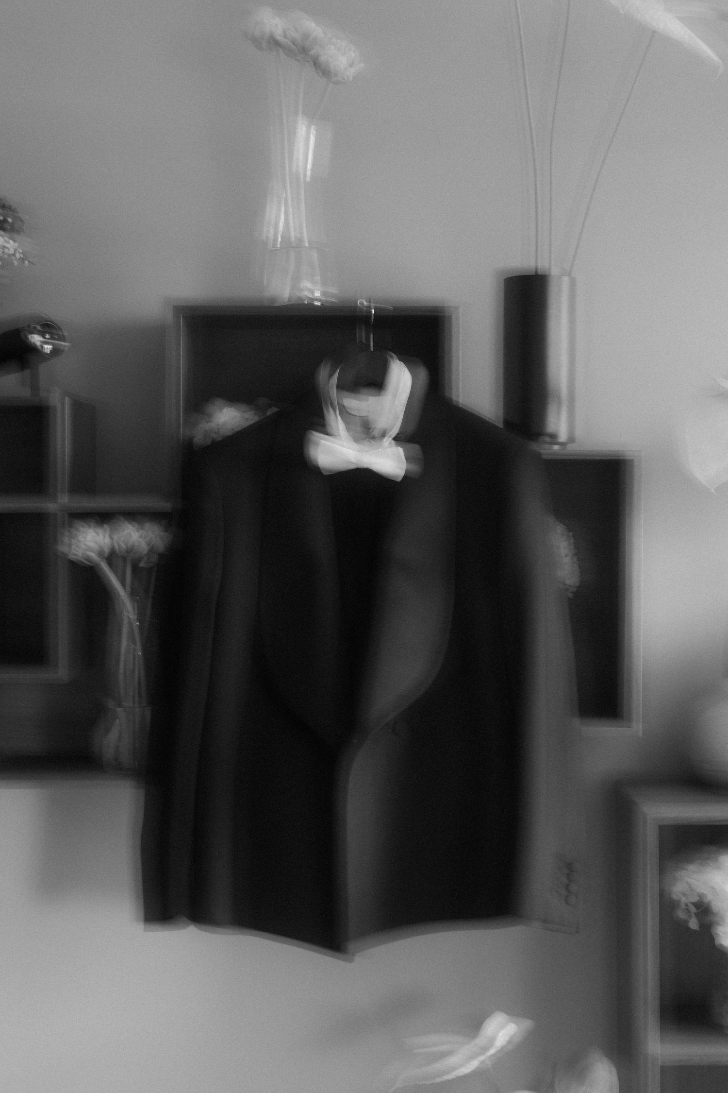 An artistic blurred black and white photo of a formal suit jacket on display.