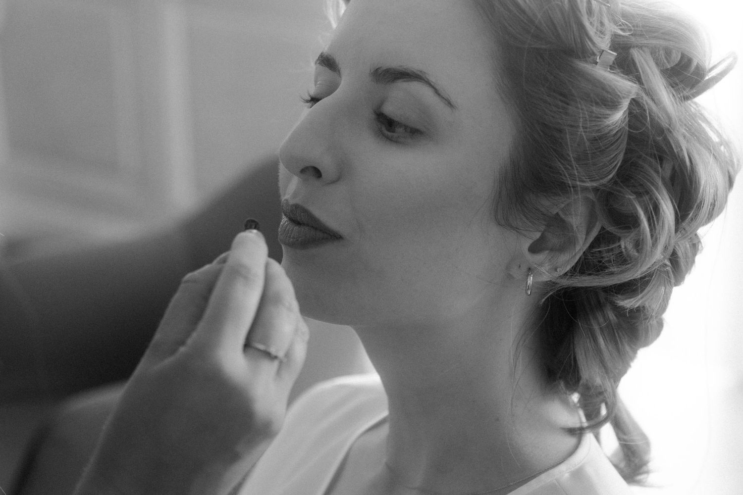 Close-up shots of detailed hair styling with curls and pins in black and white.